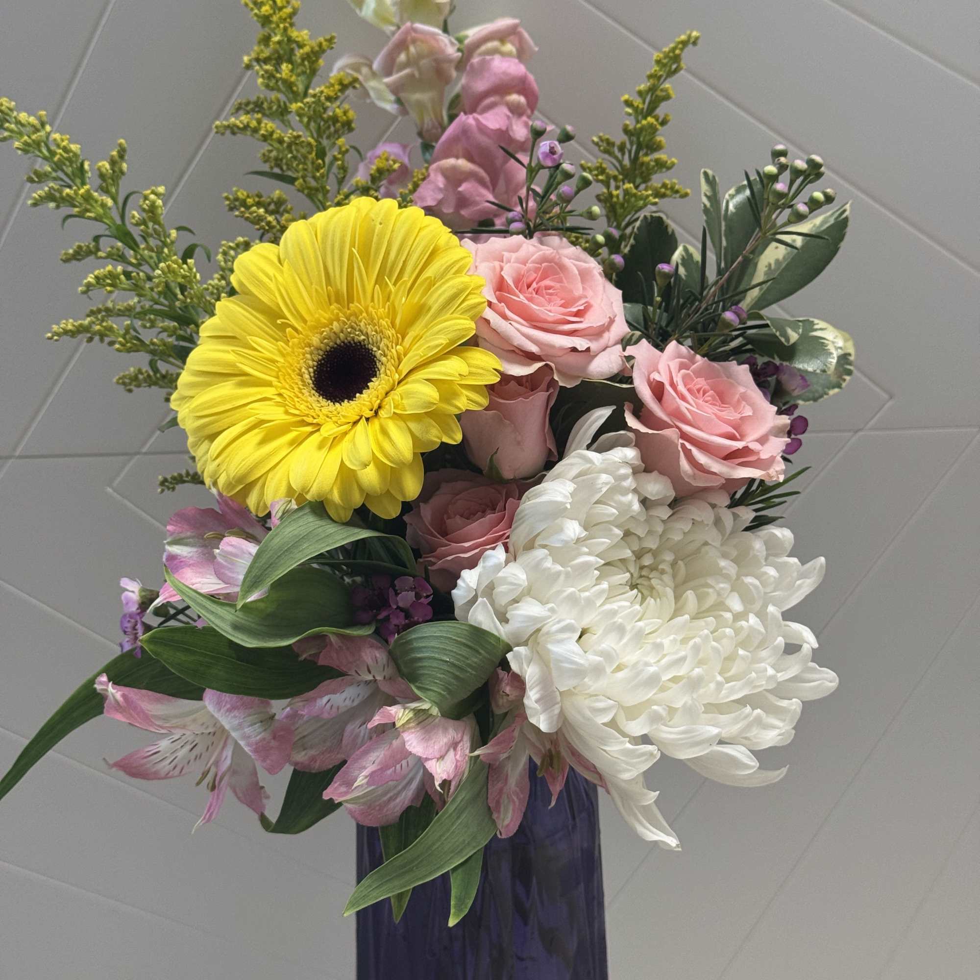 Bouquet of pink roses, white chrysanthemum, and yellow gerbera in a vase