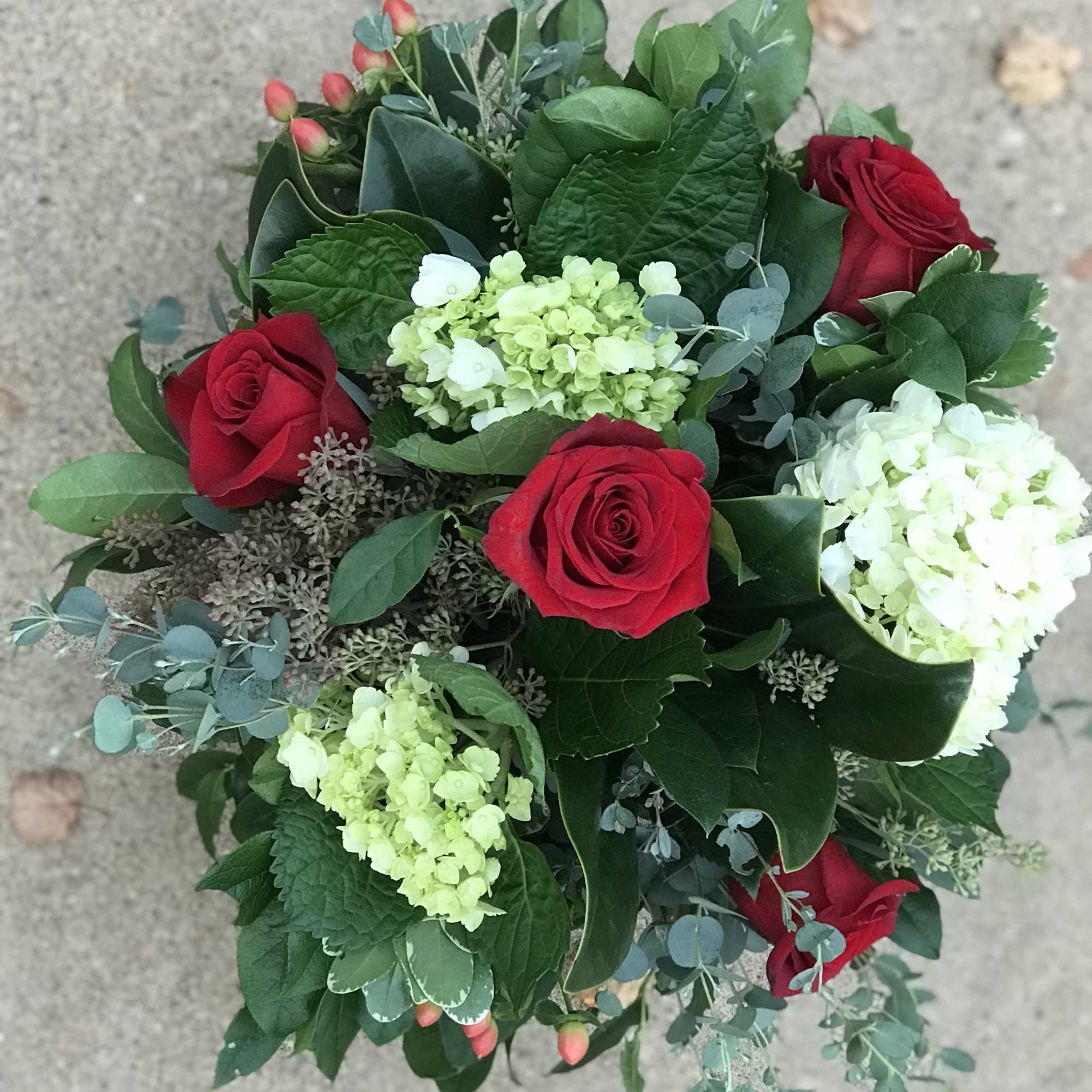 Bouquet of red roses and pale green hydrangeas with eucalyptus