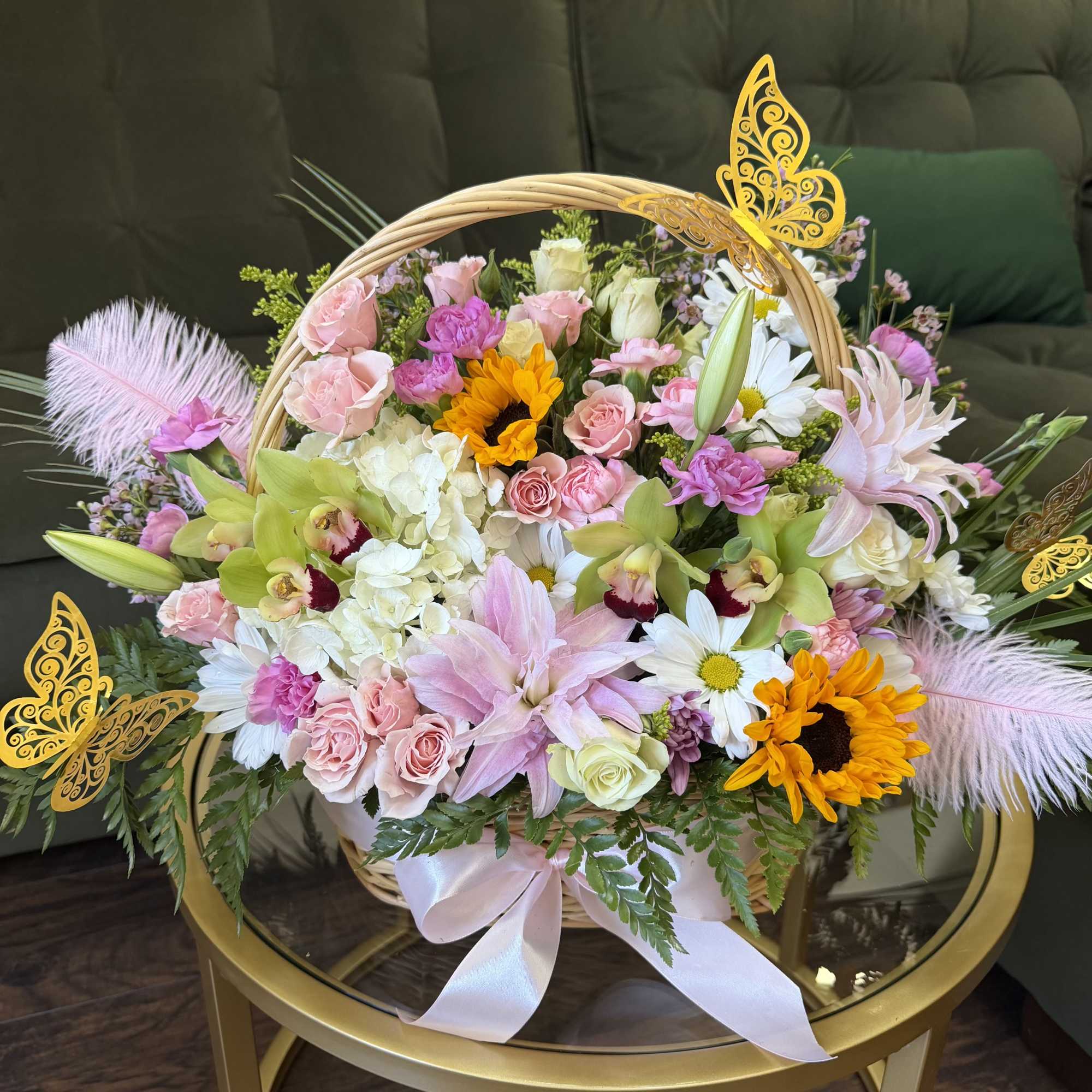 An enchanting garden-style luxury basket overflowing with delicate blush and pastel blooms