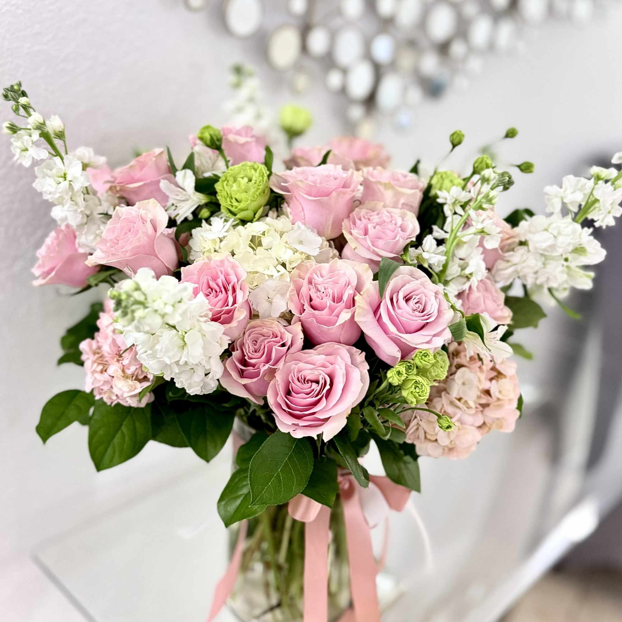 A vase arrangement designed in soft pink tones with a light, balanced