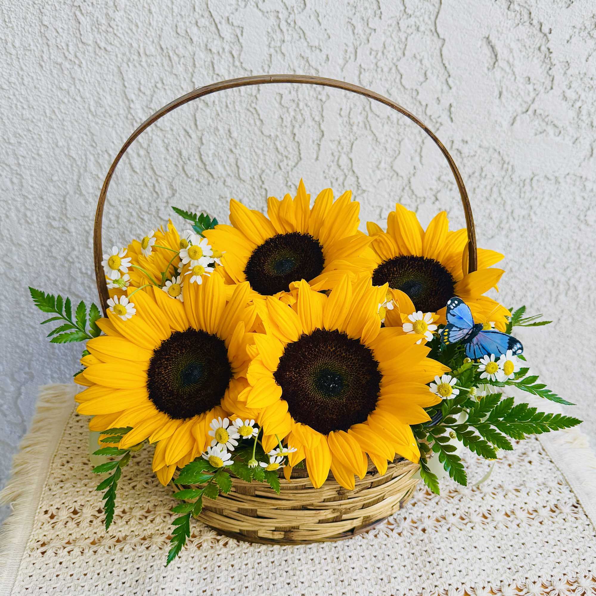  Rustic basket crafted with beautiful sunflowers, seasonal foliage, ornamental chamomile and