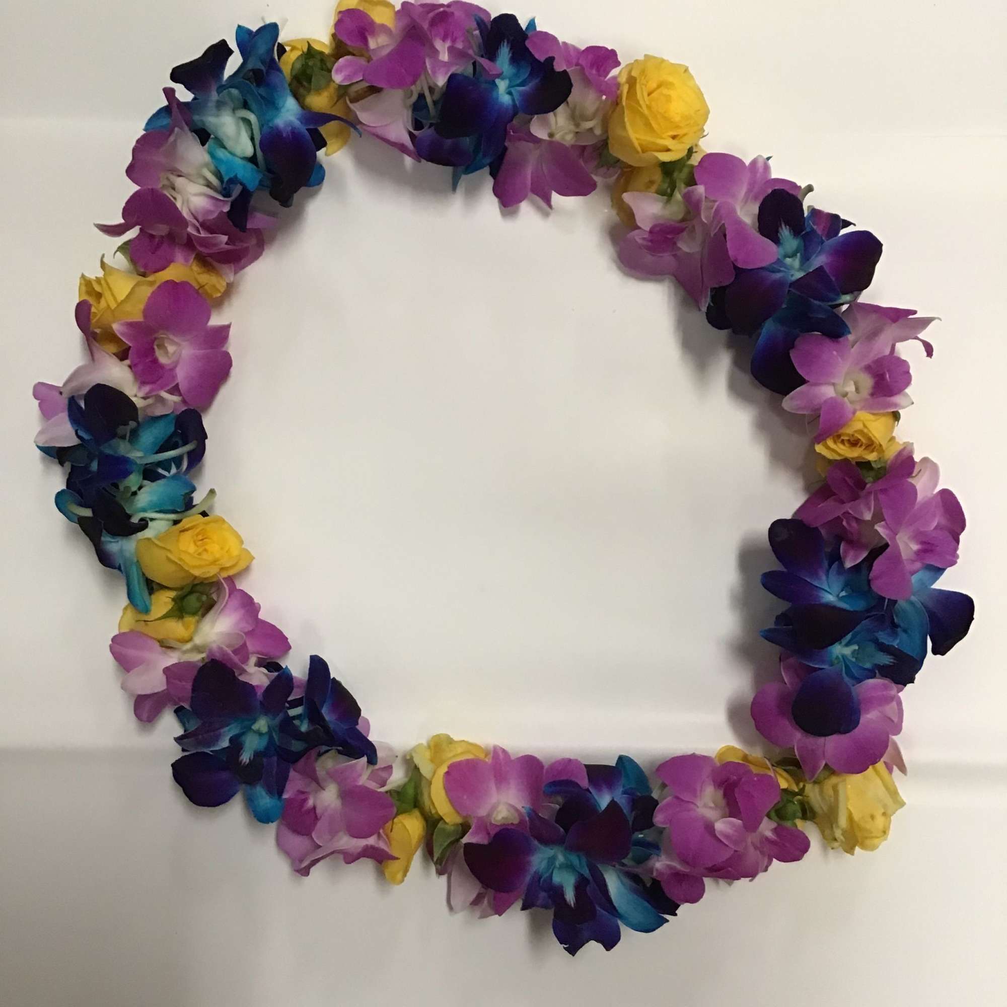 Colorful floral wreath with purple, blue, and yellow blooms