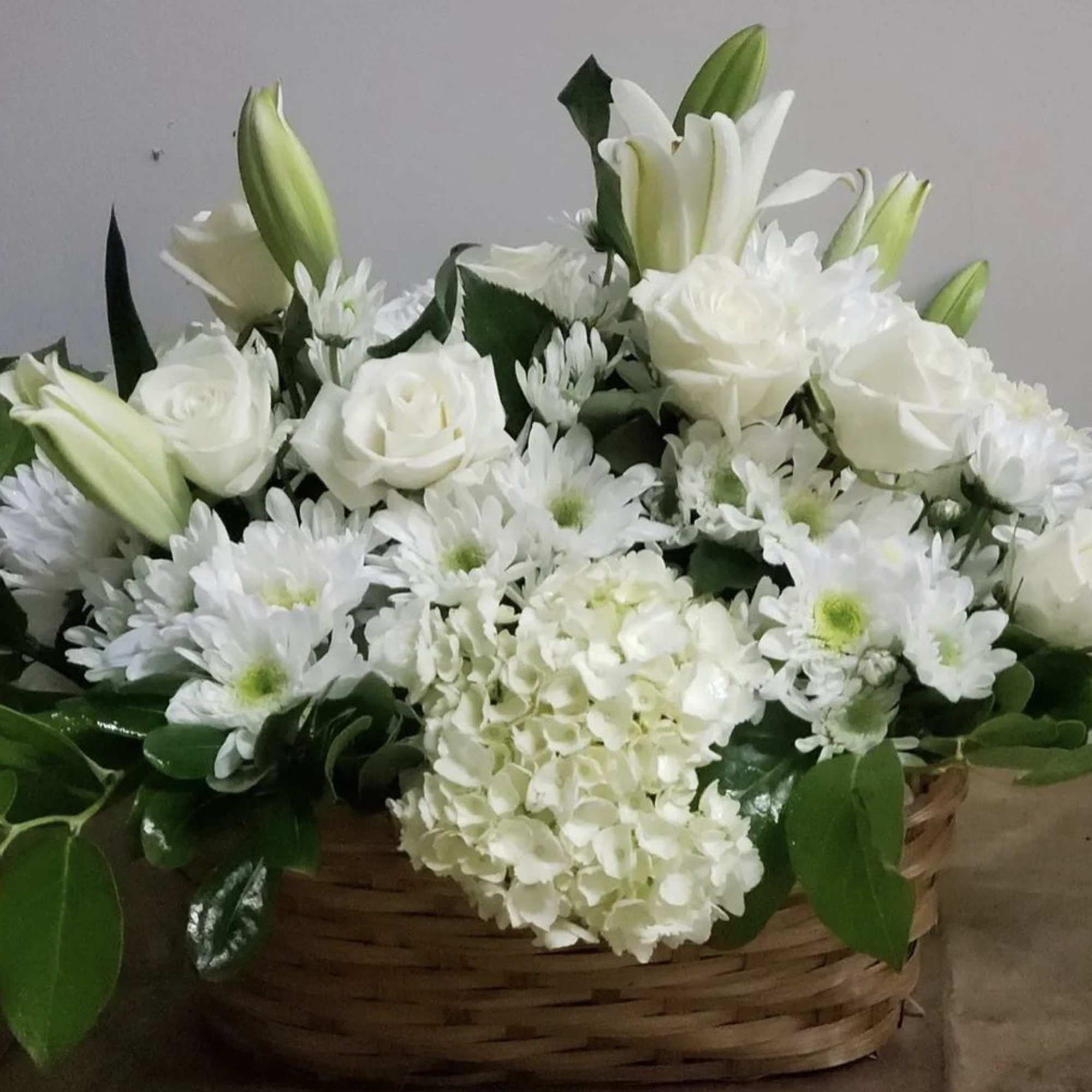 White flowers arranged in a wicker basket