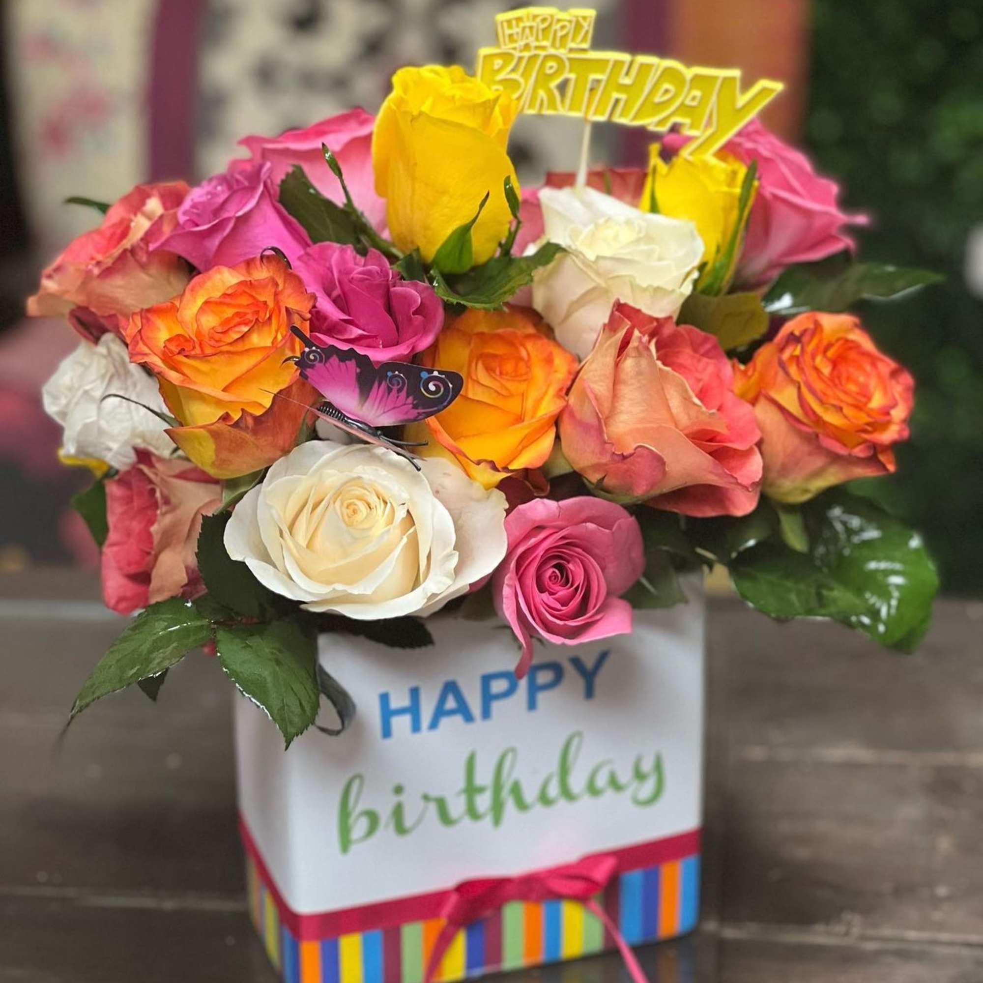 Bouquet of multicolored roses in a birthday gift box