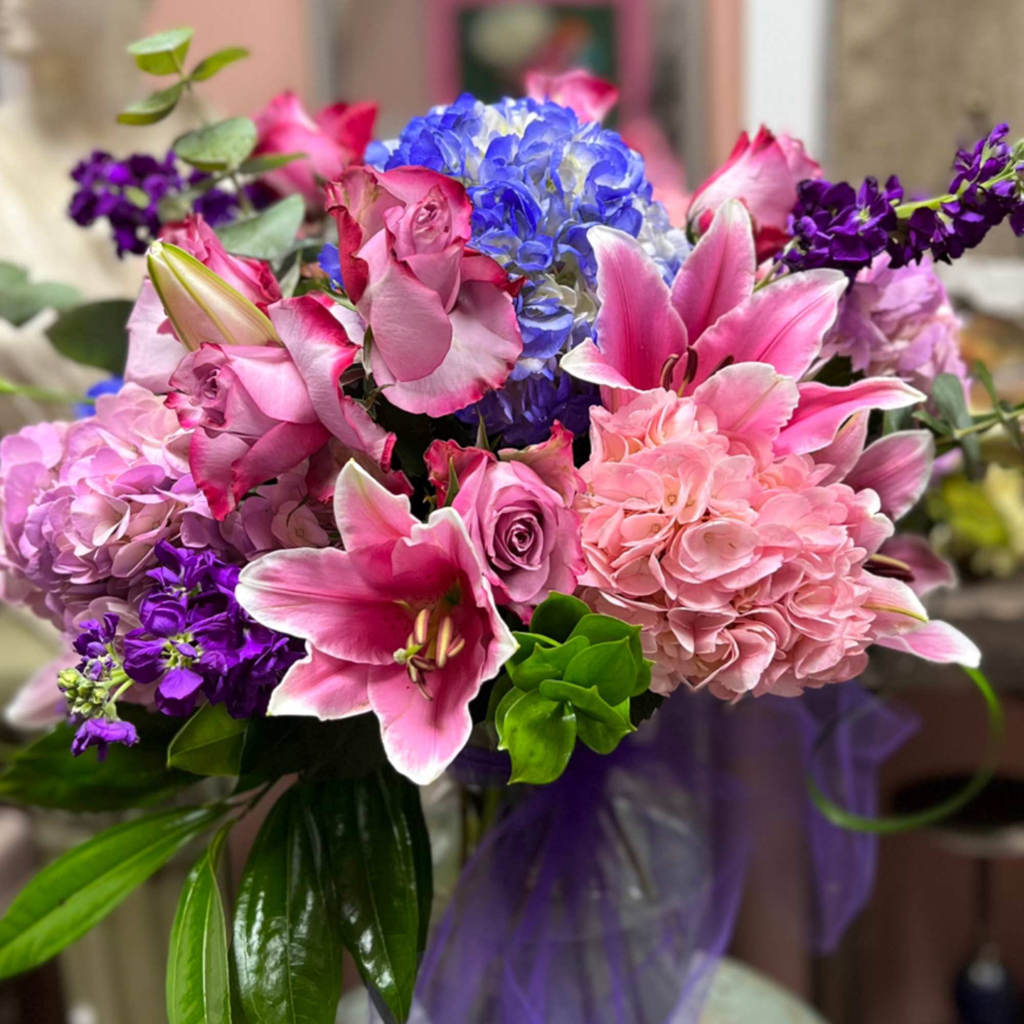 Pink and purple bouquet with lilies, roses, and hydrangea