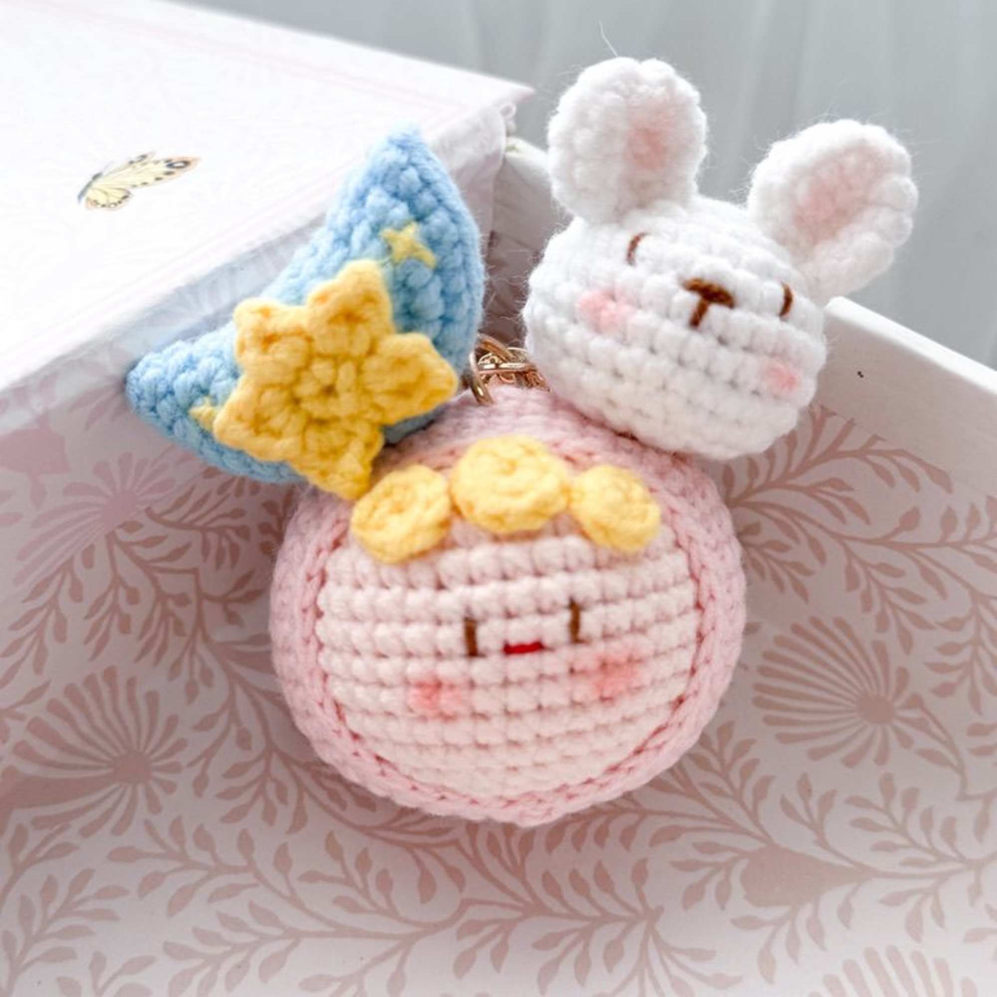 Crocheted bunny and star charms in a gift box