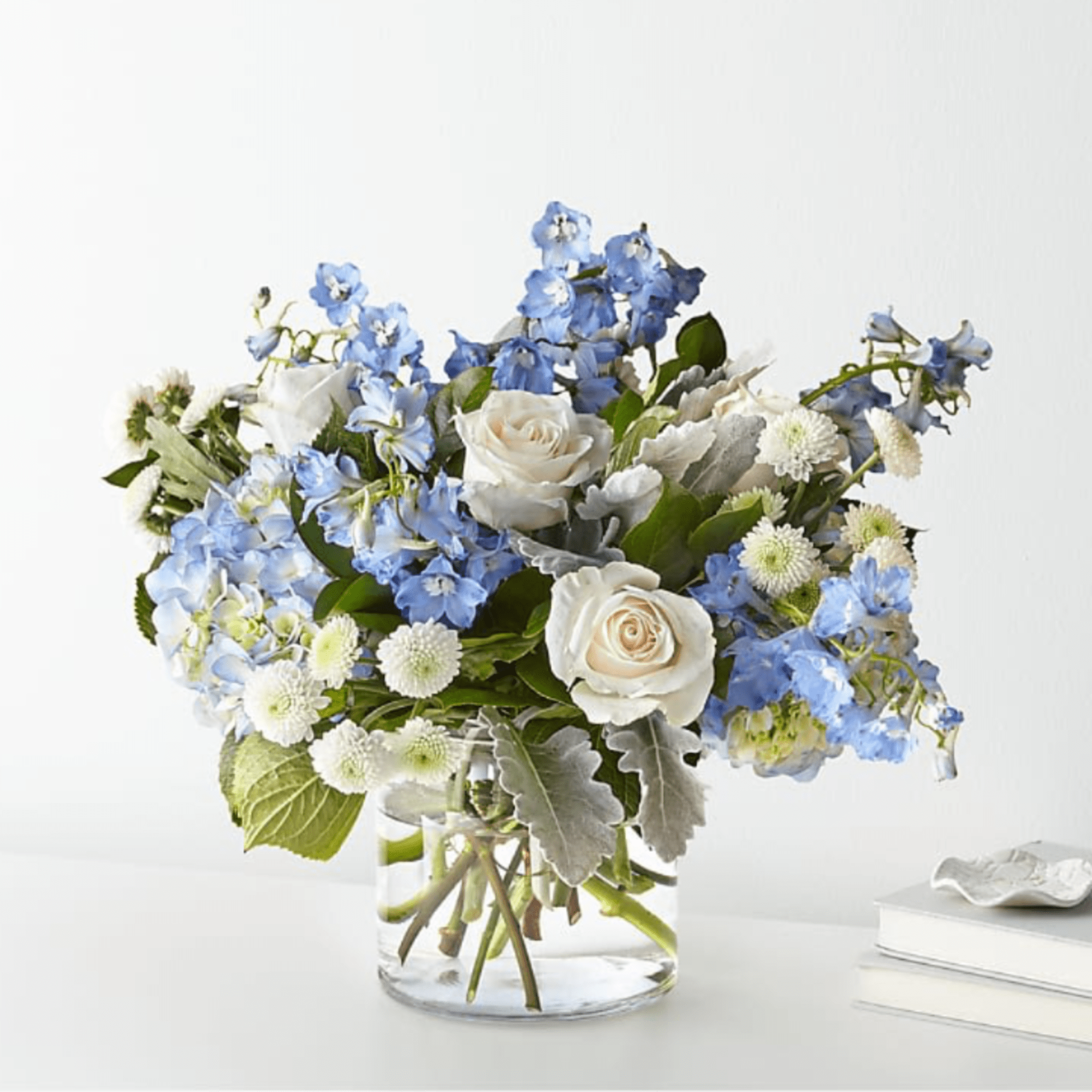Blue and white bouquet in a clear glass vase