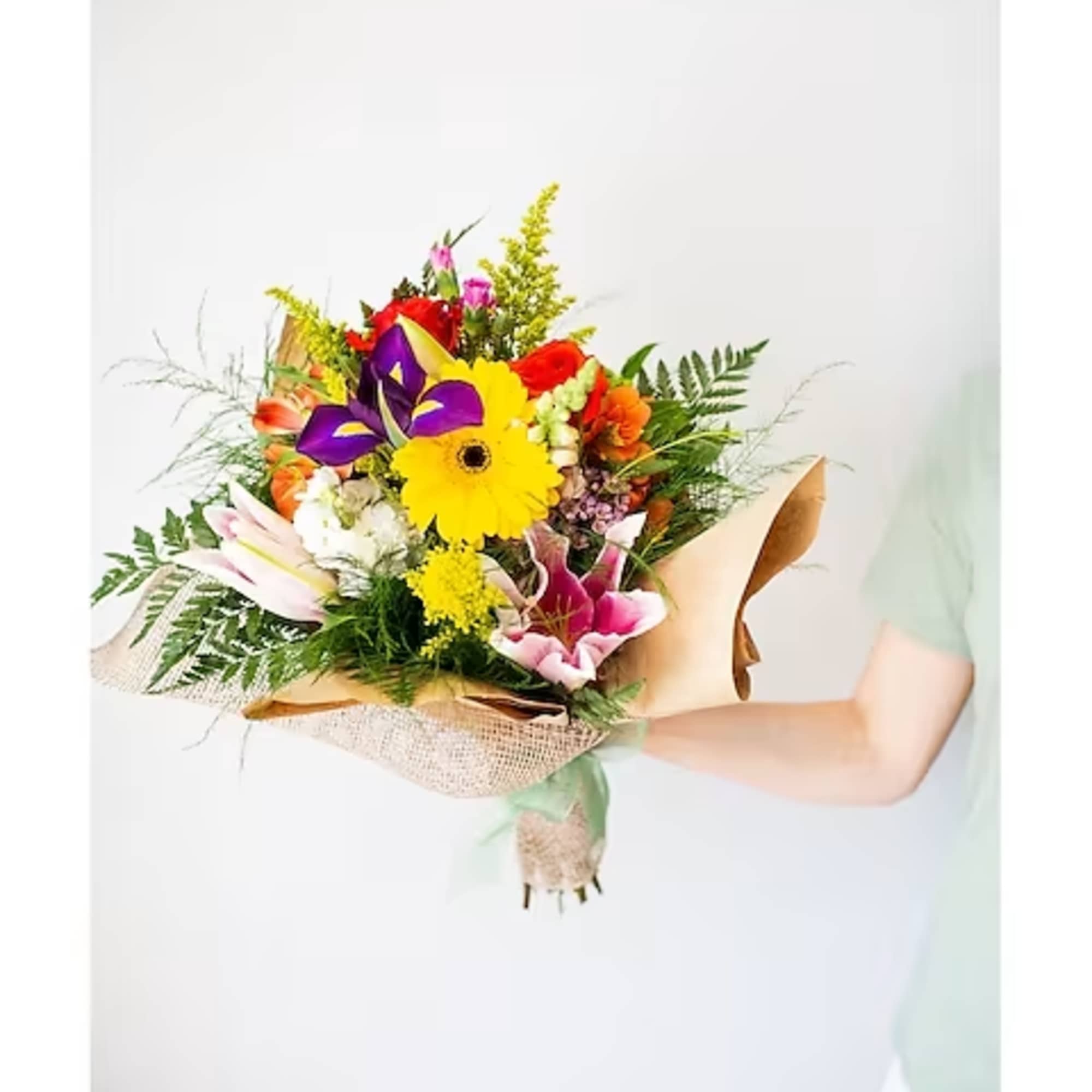 Colorful mixed bouquet wrapped in burlap paper