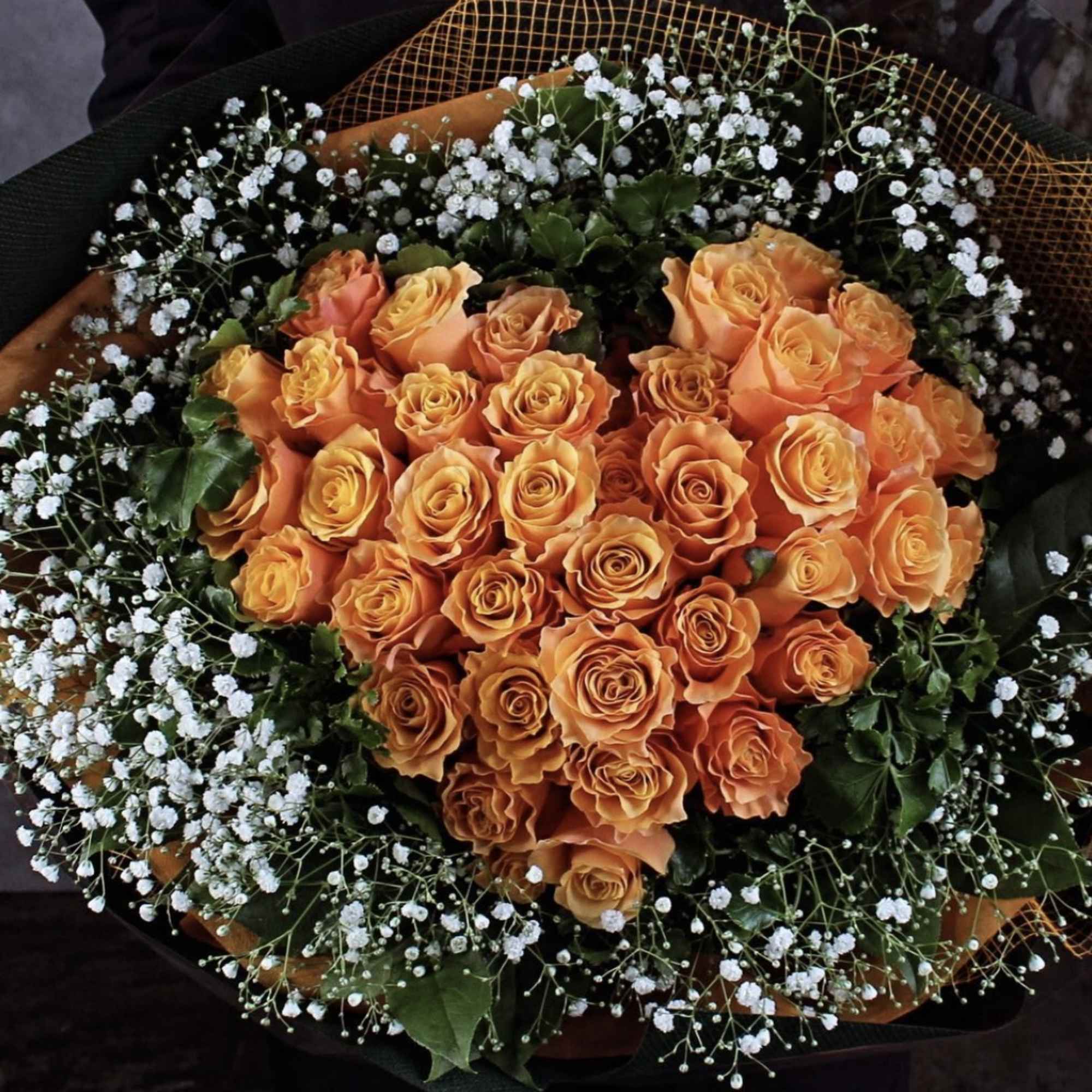 Bouquet of orange roses with white baby's breath