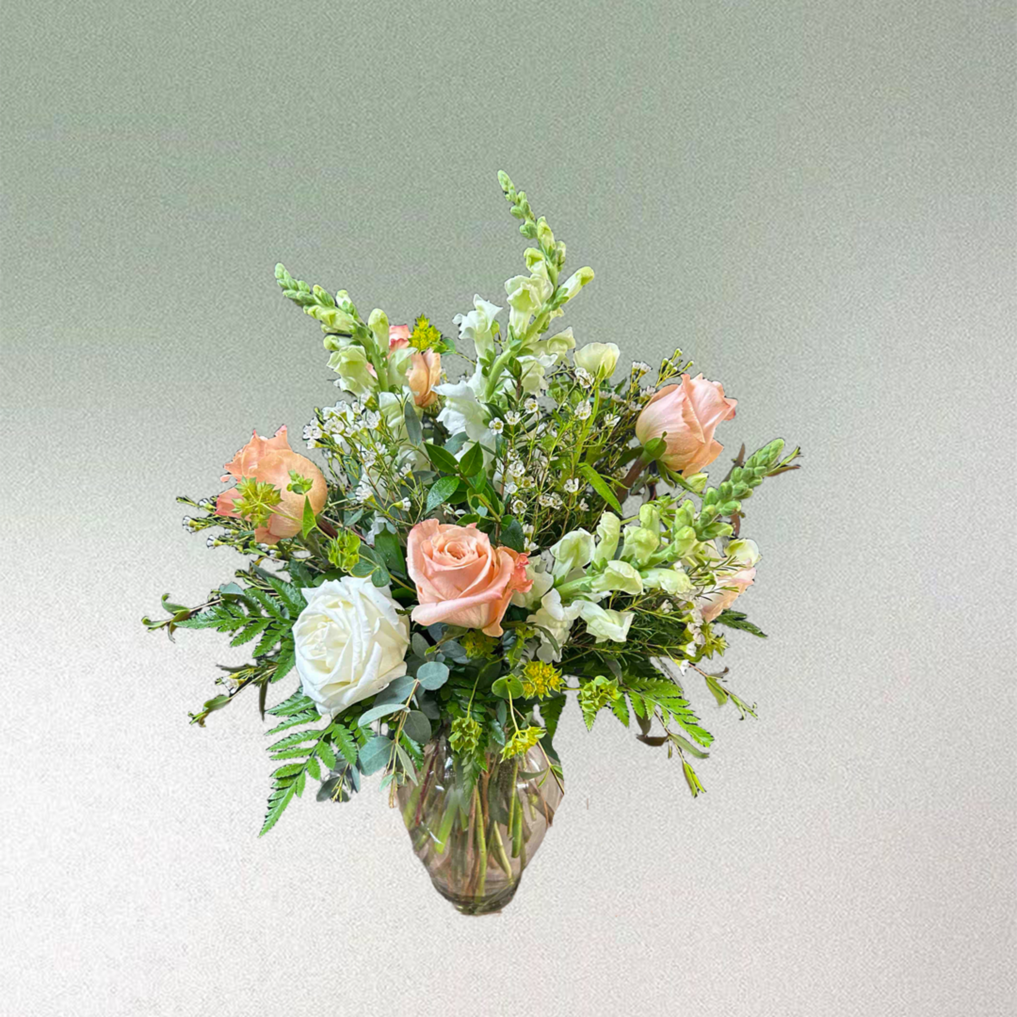 Elegant bouquet with peach and white flowers.