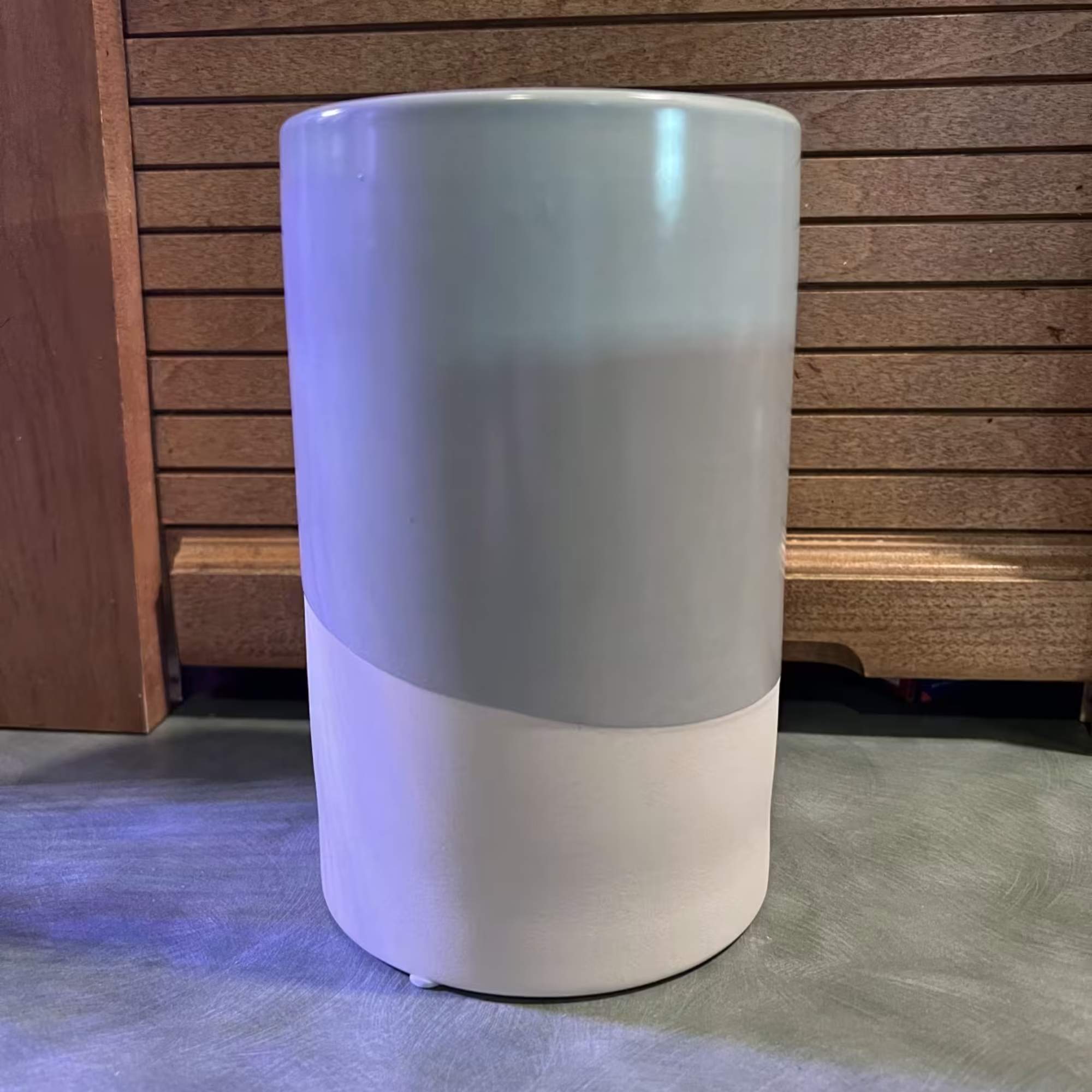 White and gray cylindrical pedestal stand