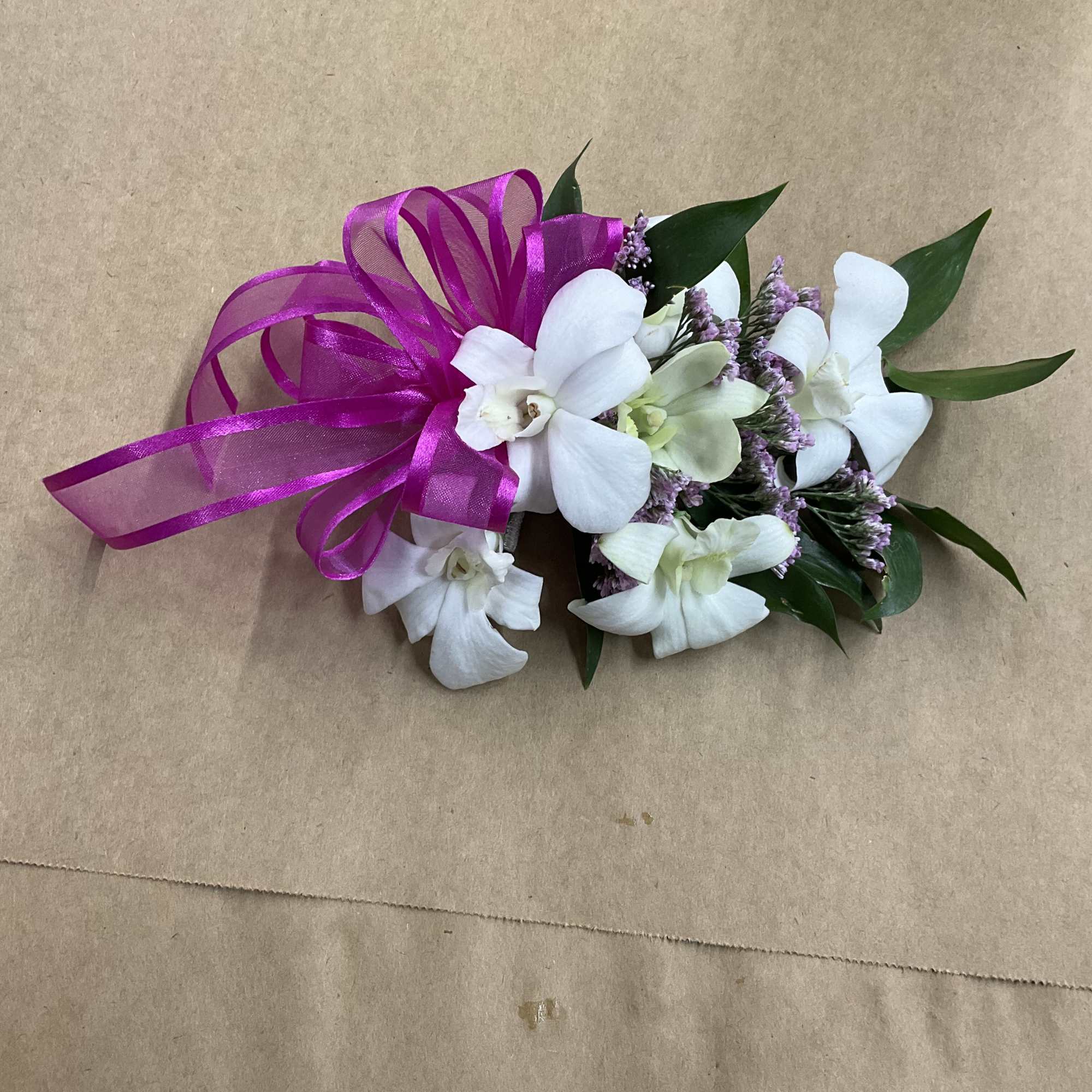 A beautiful orchid corsage perfect for your next prom, graduation or even