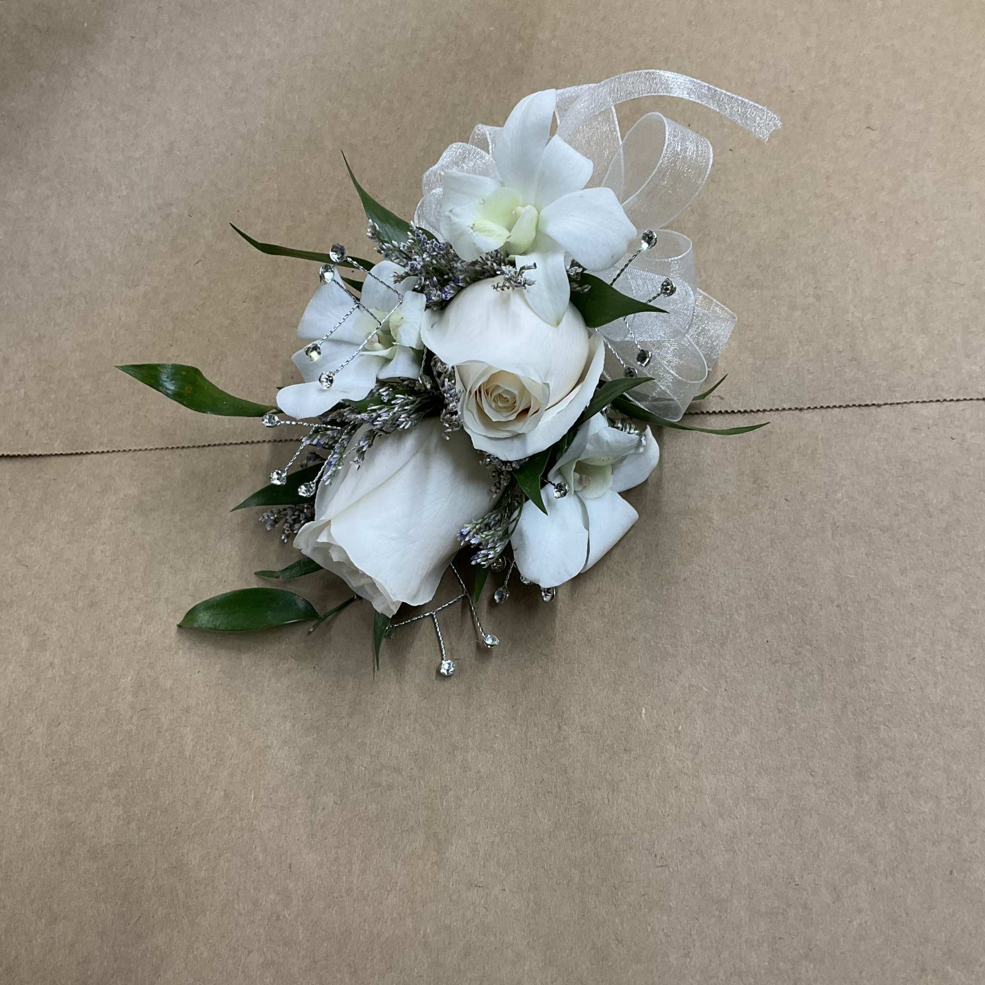 A beautiful rose corsage with dendrobium. Perfect for your prom wedding or
