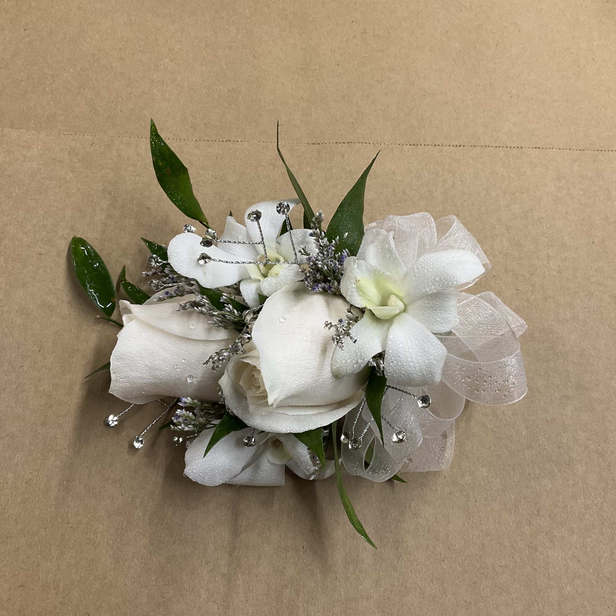 A beautiful rose corsage with dendrobium. Perfect for your prom wedding or