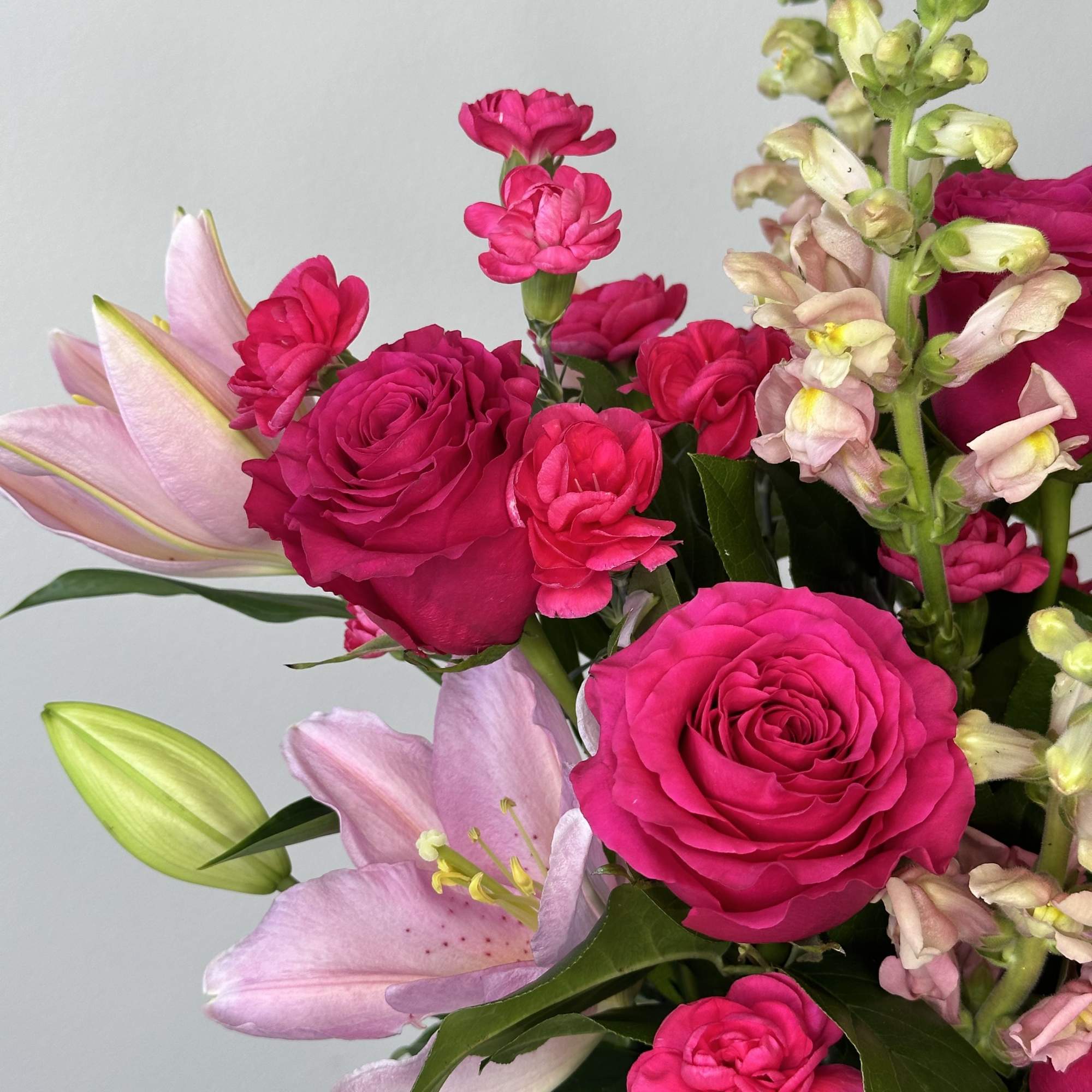 Bouquet of hot pink roses and pale pink lilies