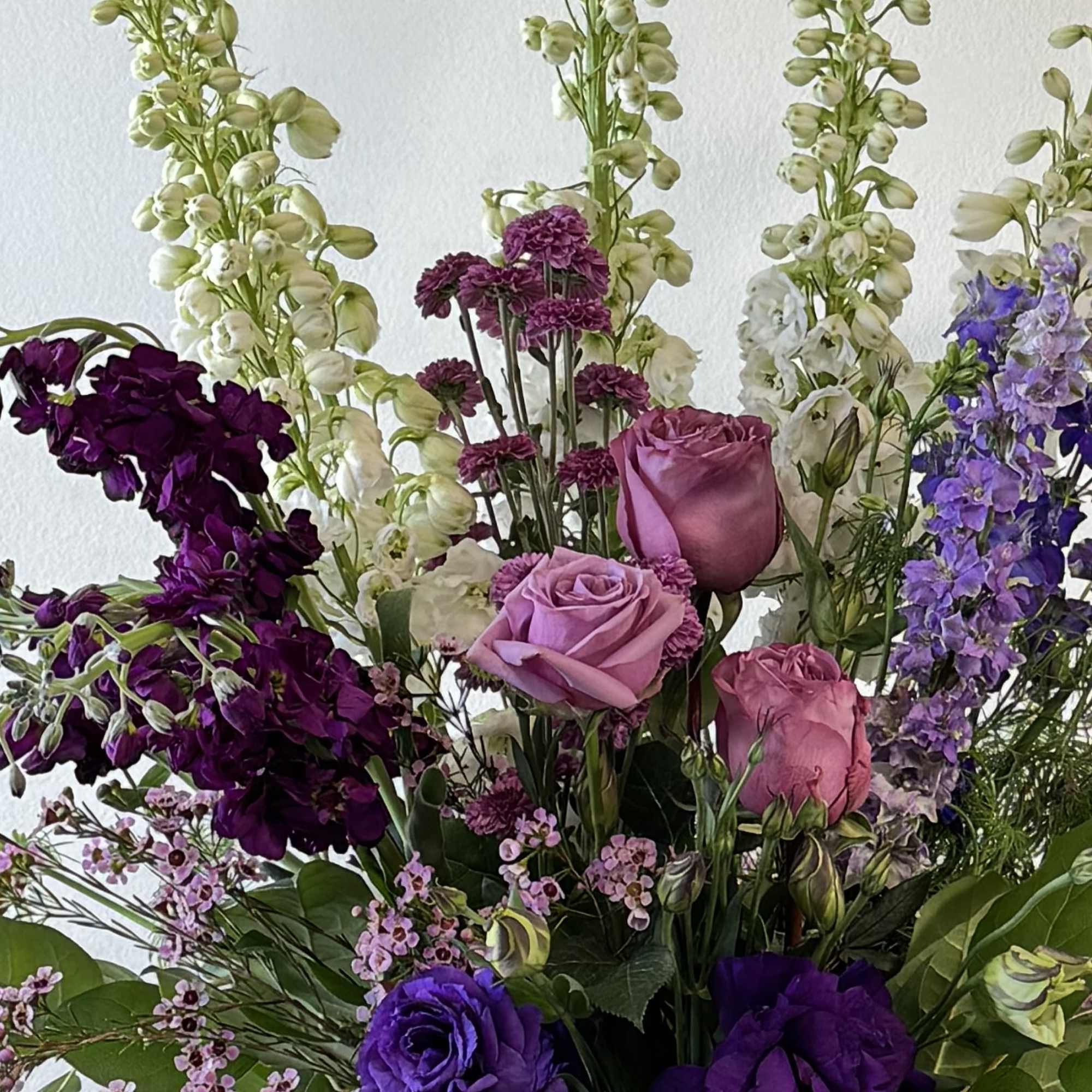 Tall bouquet of purple and pink flowers with white spikes