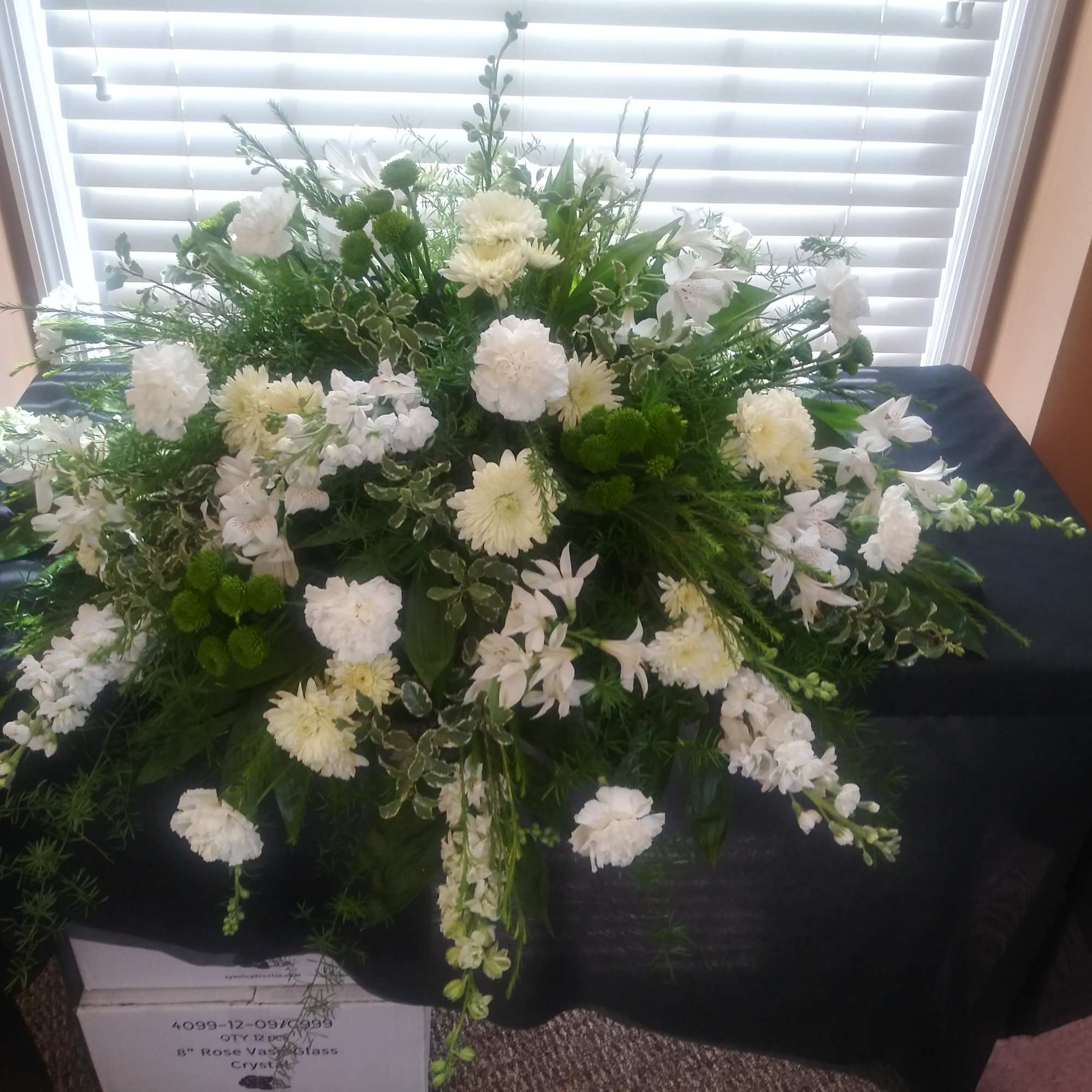Large white and green floral arrangement on a table
