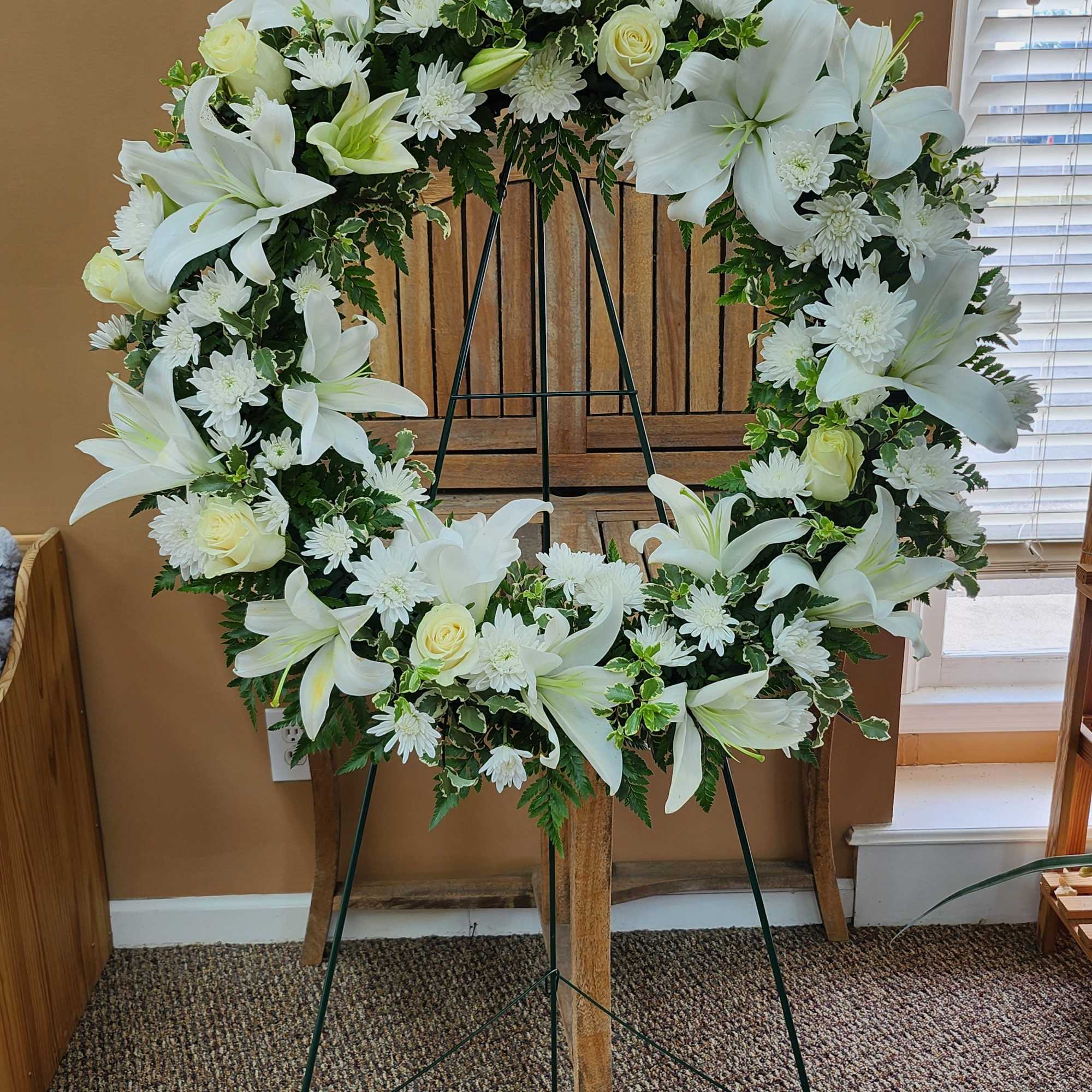 White floral wreath on a standing easel