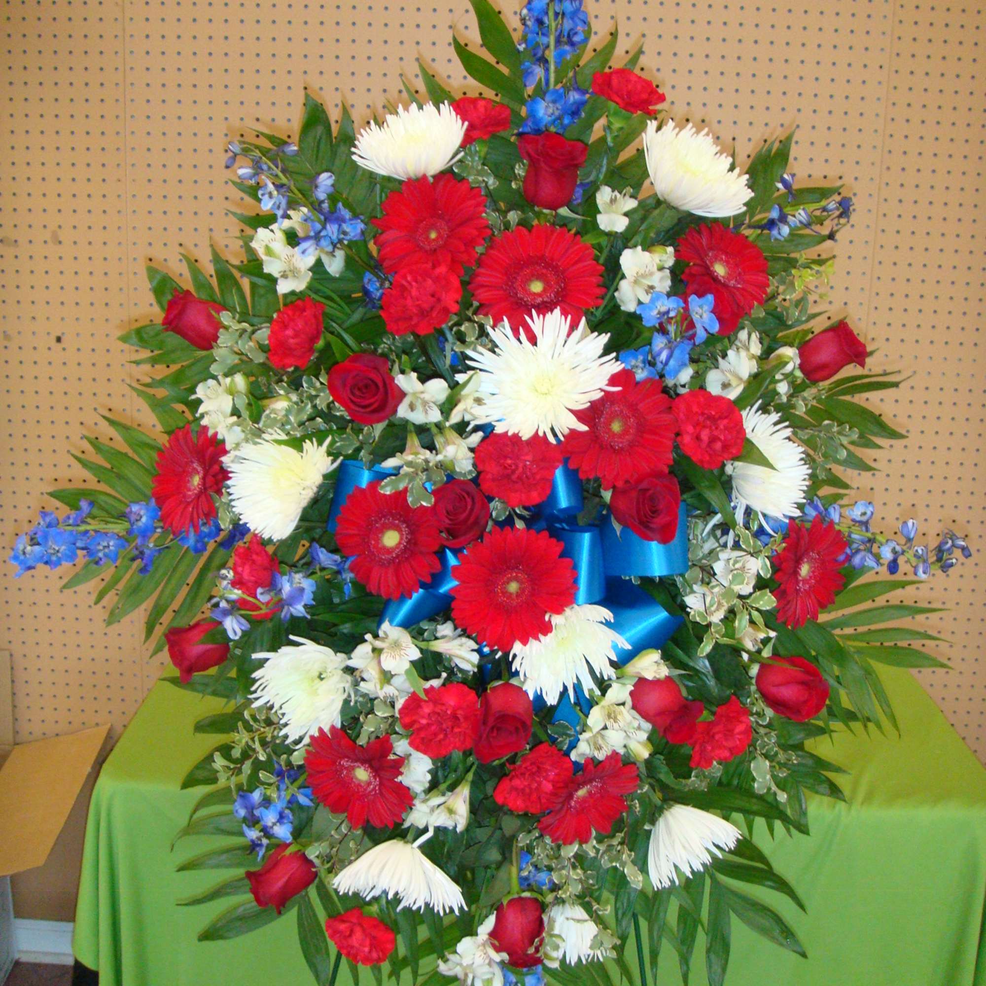 Large standing floral spray with red, white, and blue flowers