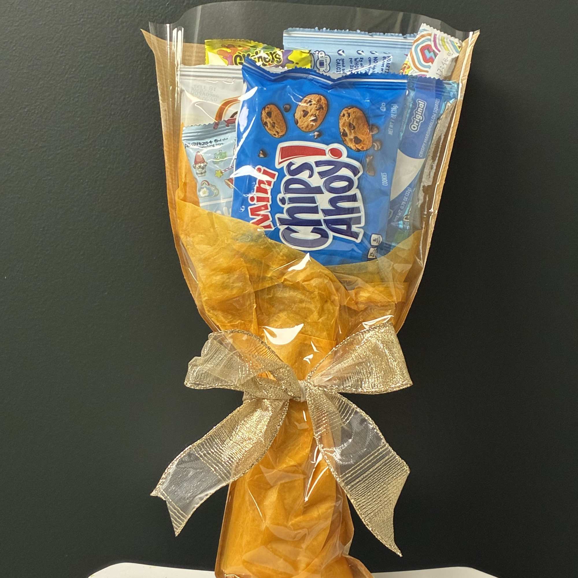 A fun and colorful arrangement filled with kid-favorite snacks and sweet treats!