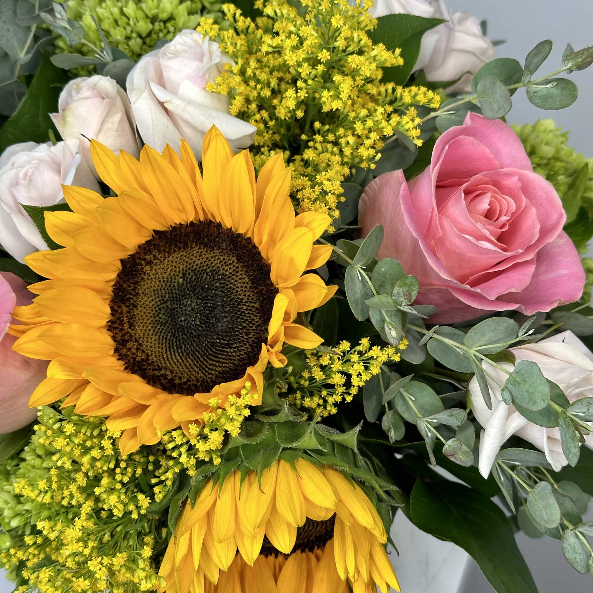 Bouquet with sunflowers, pink and white roses, and yellow filler flowers