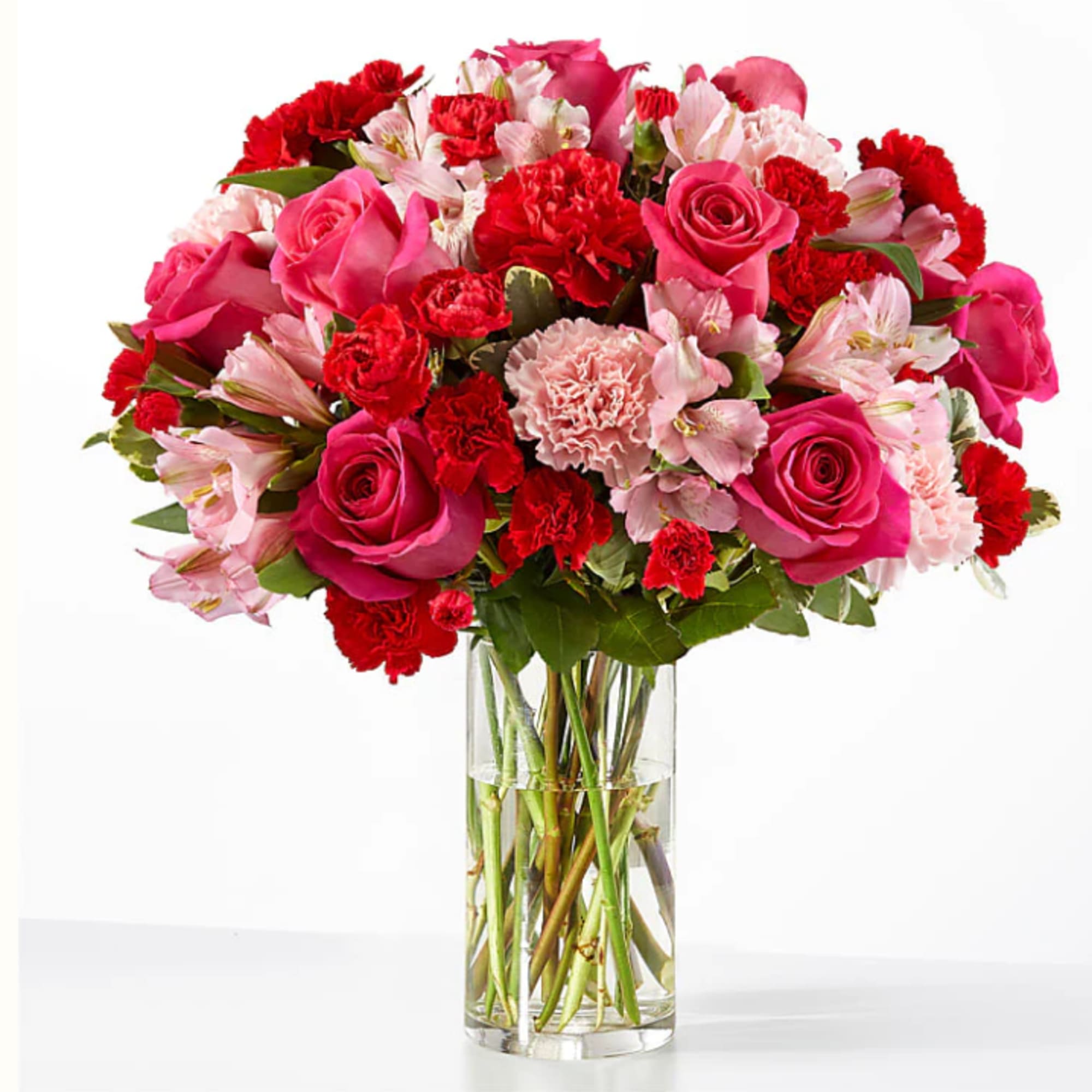 Pink and red mixed bouquet in a clear glass vase