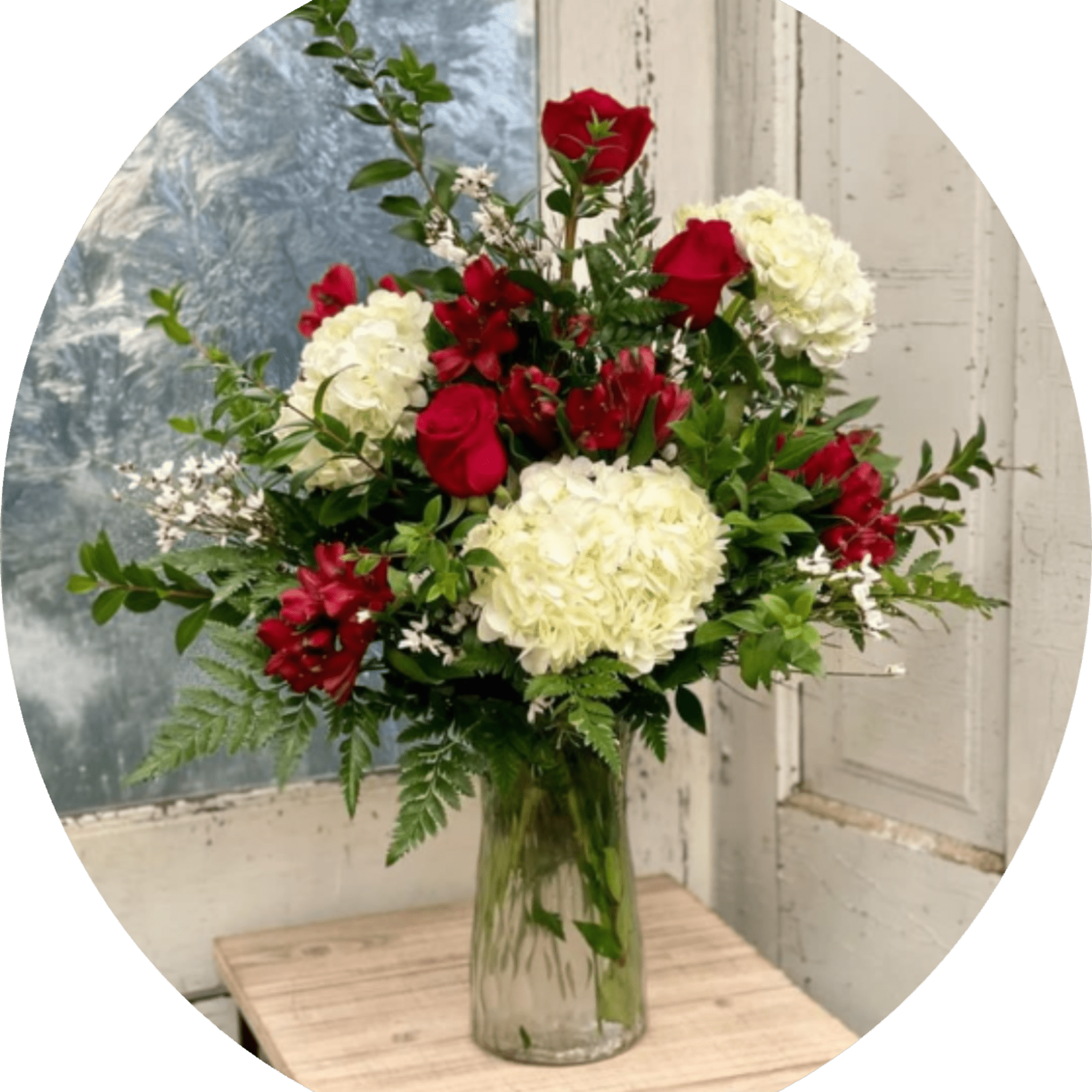 Rich red roses paired with creamy white hydrangeas give this flower arrangement