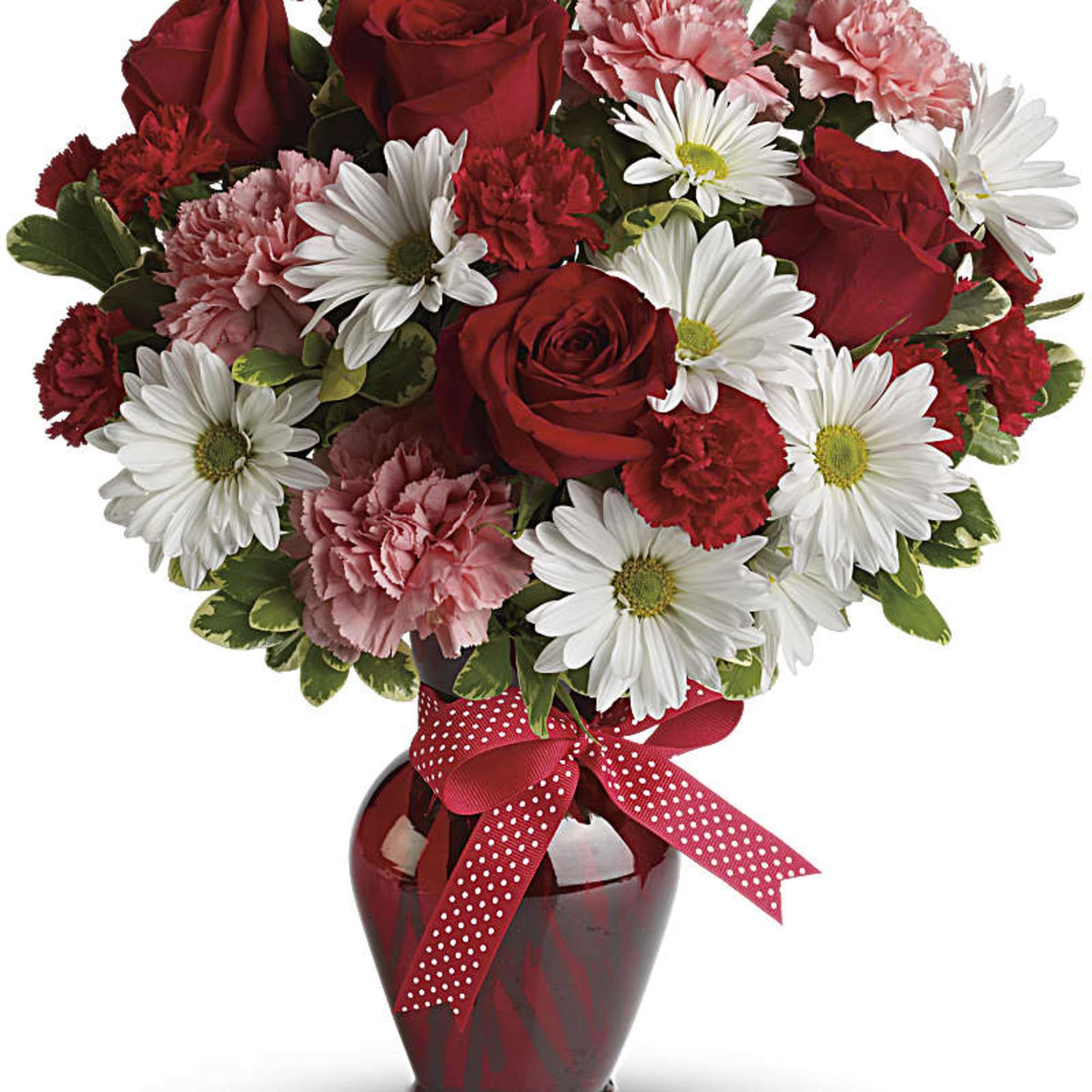 Red roses, pink carnations, and white daisies in a red vase with a polka-dot ribbon