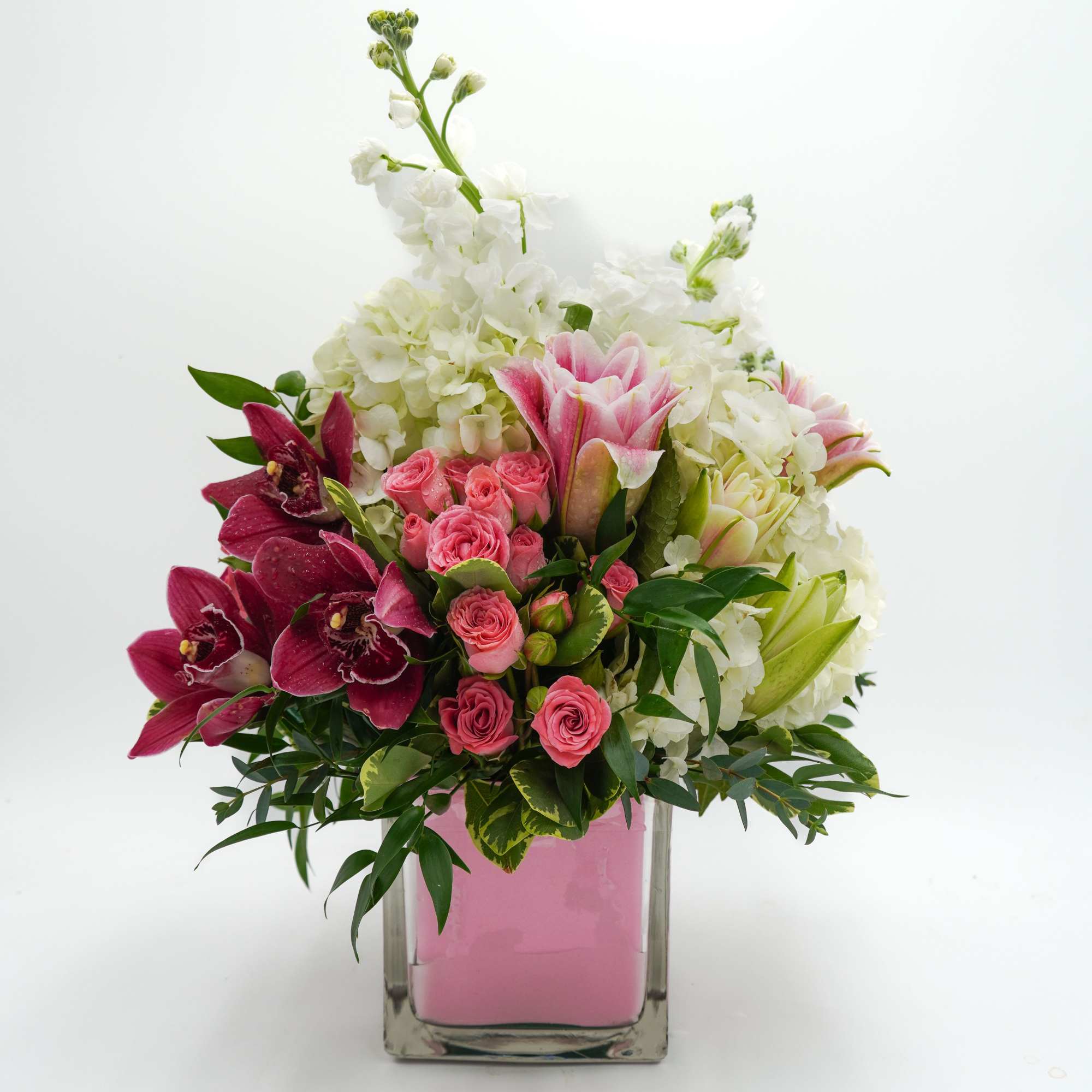 A lush cloud of white hydrangeas sets the stage for bold pink