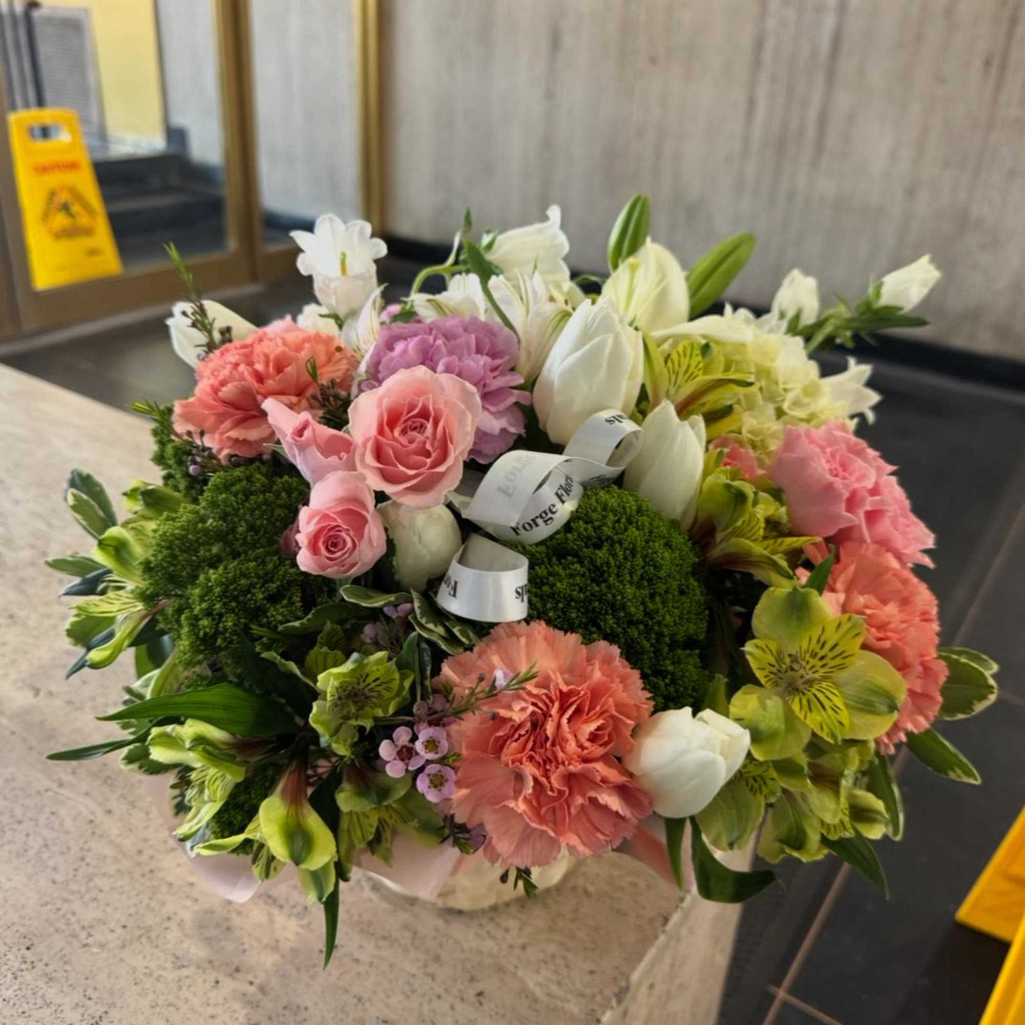 Flower basket with mixed colorful seasonal flowers. Picture is just for reference.