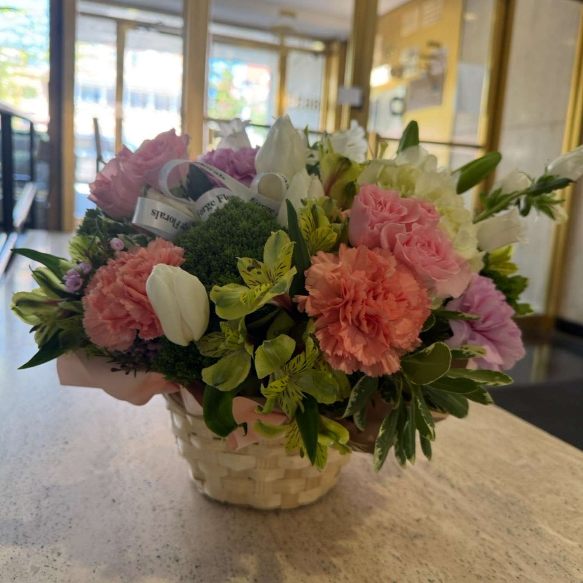 Flower basket with mixed colorful seasonal flowers. Picture is just for reference.