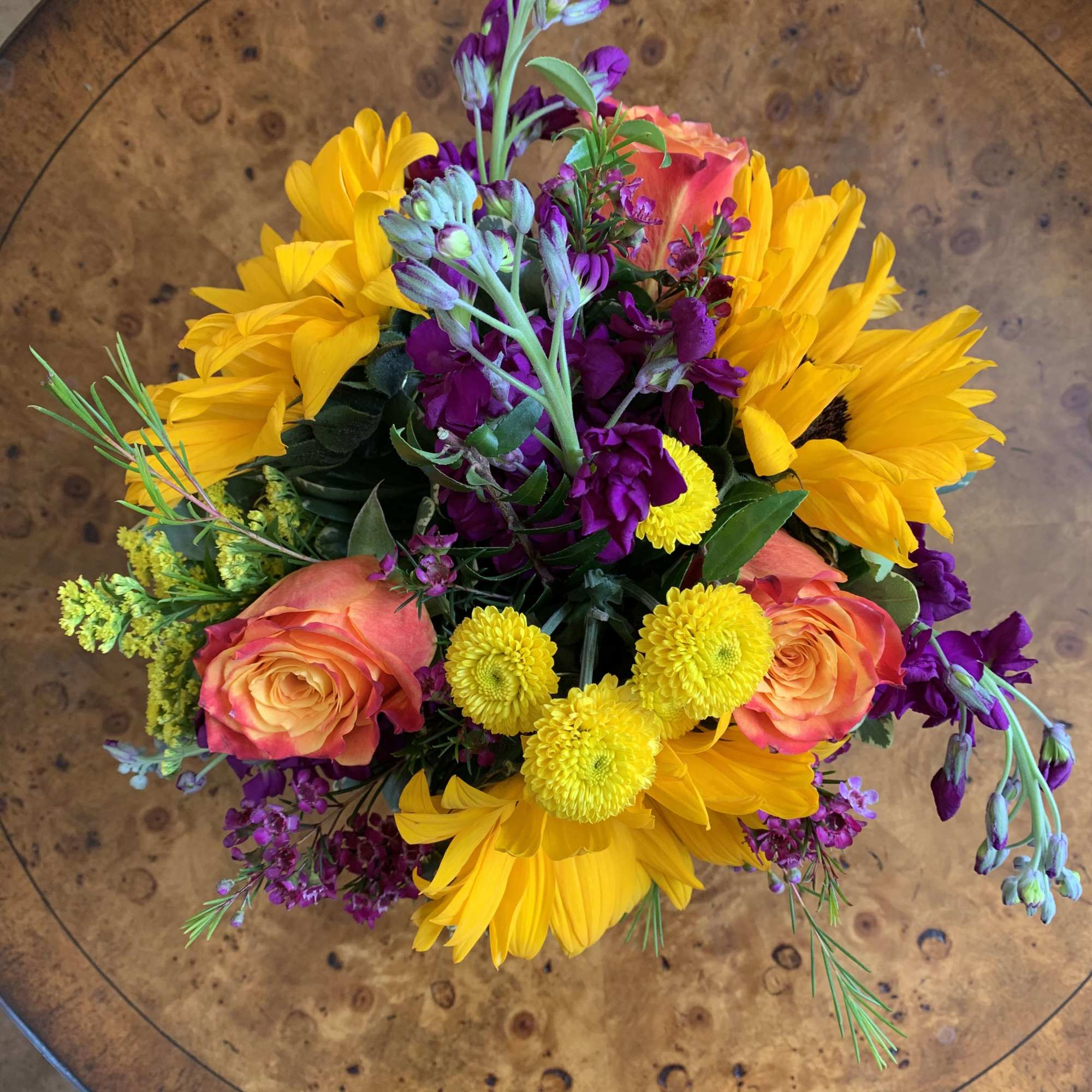 Mixed bouquet with sunflowers, roses, and purple flowers