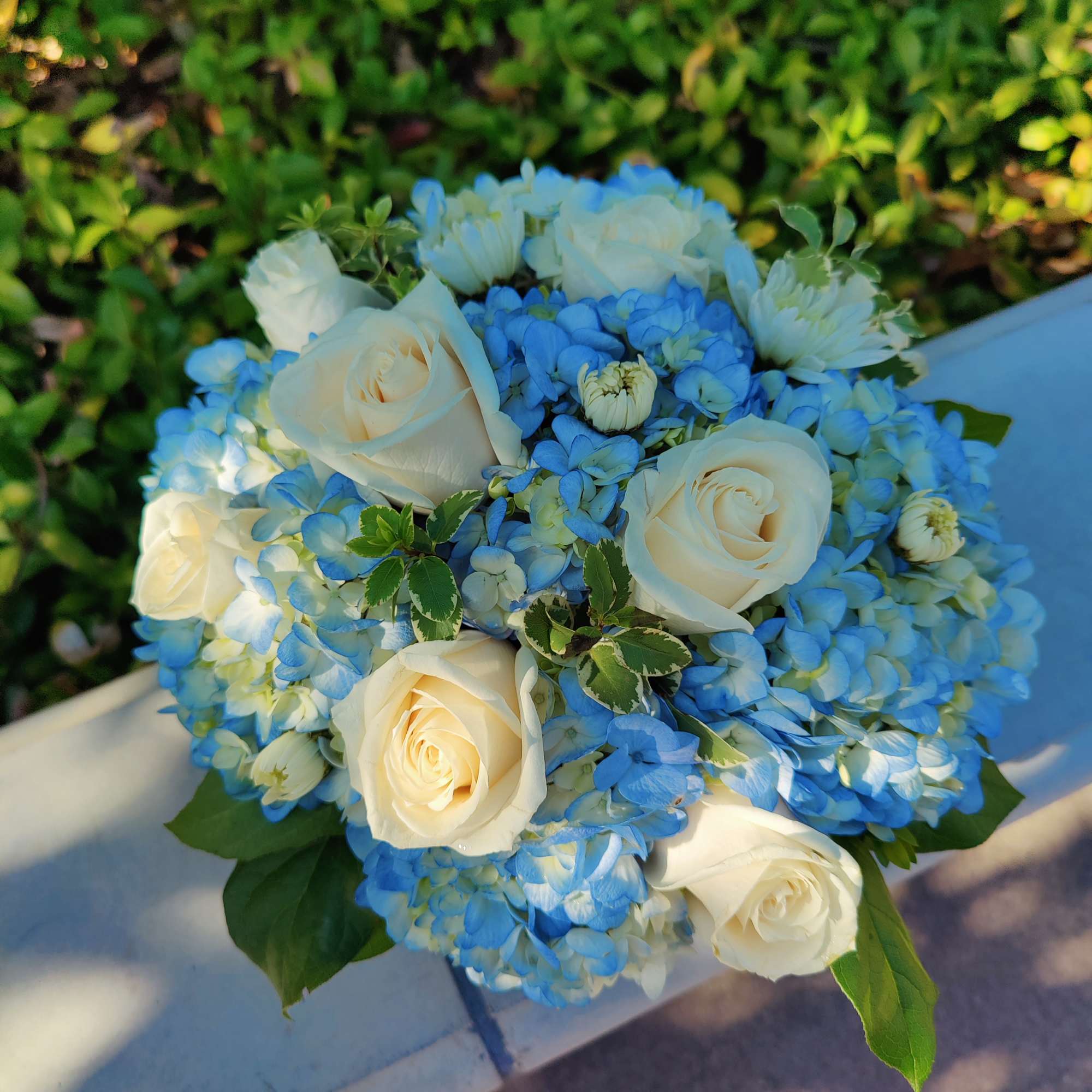 Blue hydrangea bouquet with white roses