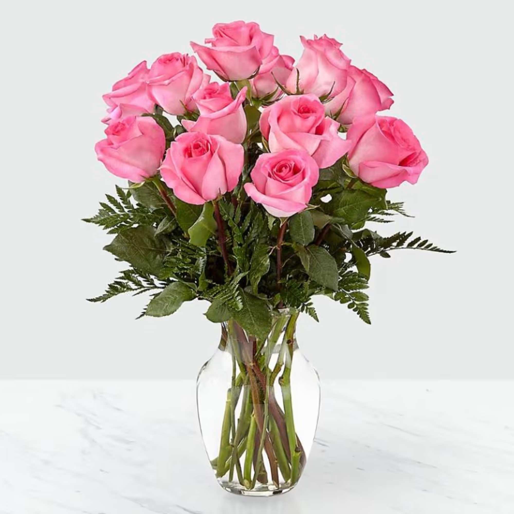 Pink roses arranged in a clear glass vase