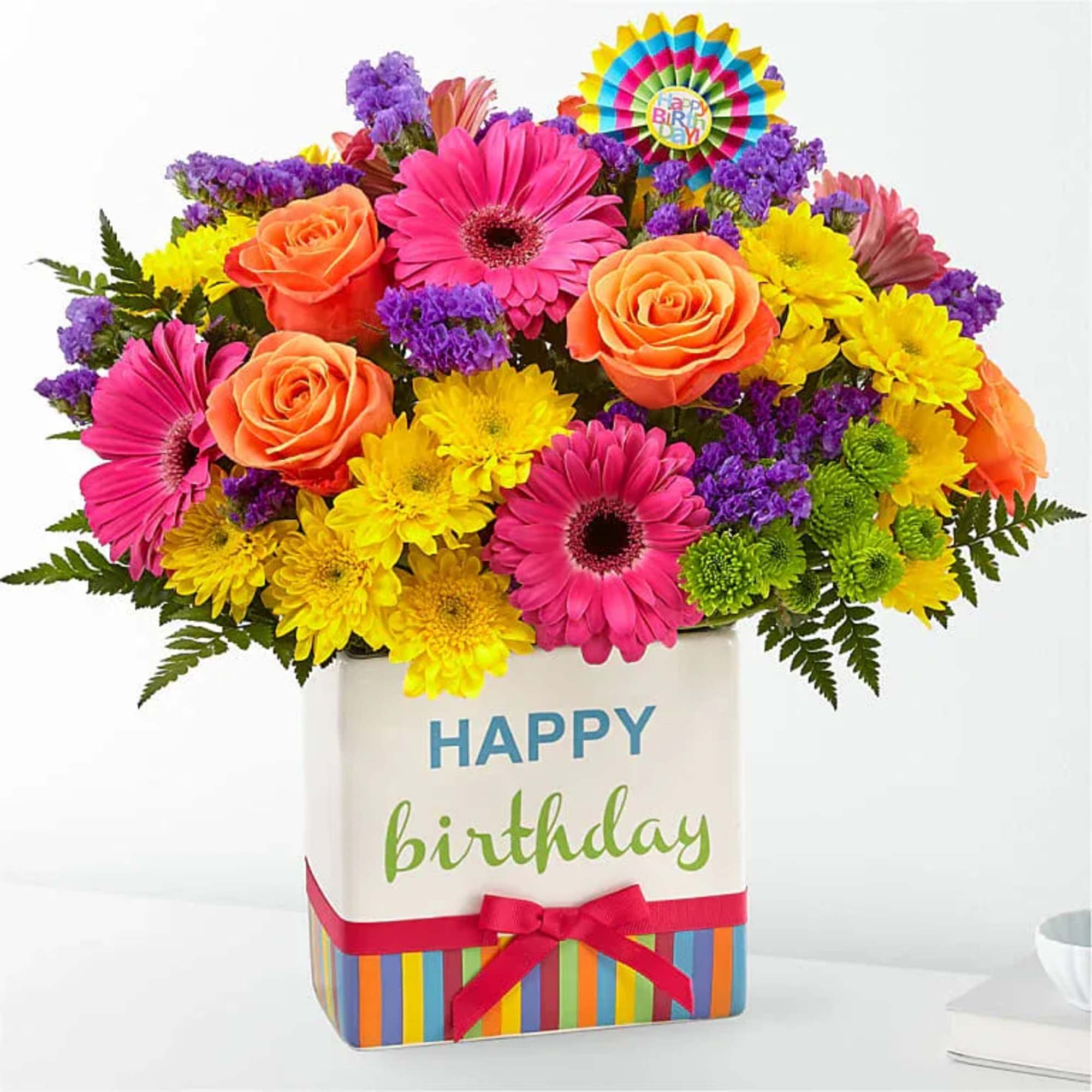 Bright mixed flower arrangement in a birthday gift box