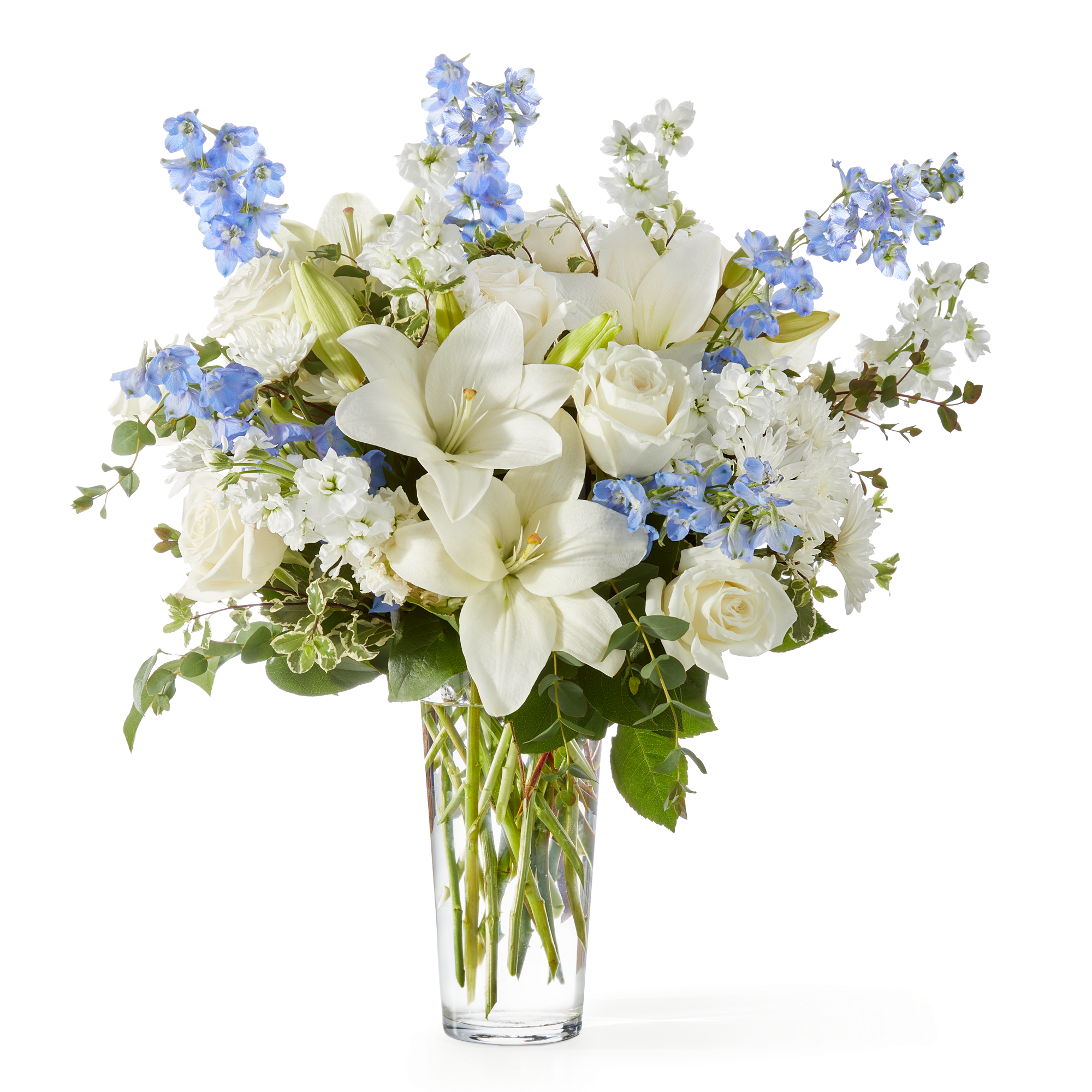 An elegant blend of white lilies, roses, and chrysanthemums accented with soft