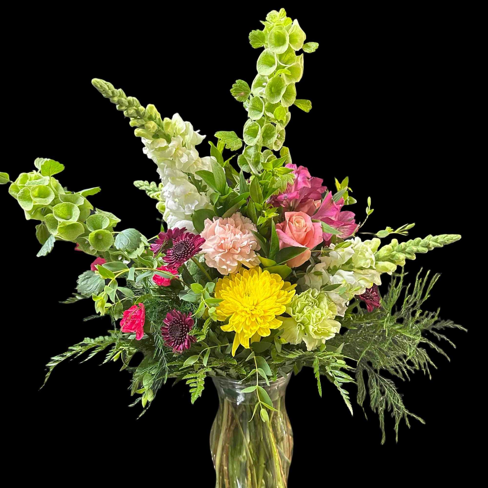Full garden-style bouquet in a clear glass vase: hydrangeas, roses, snapdragons, mums