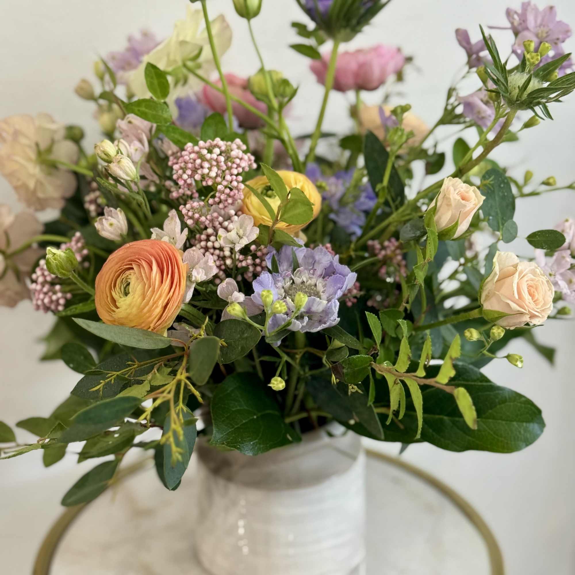 Soft pastels of lavender, peach, pink and white come together in a