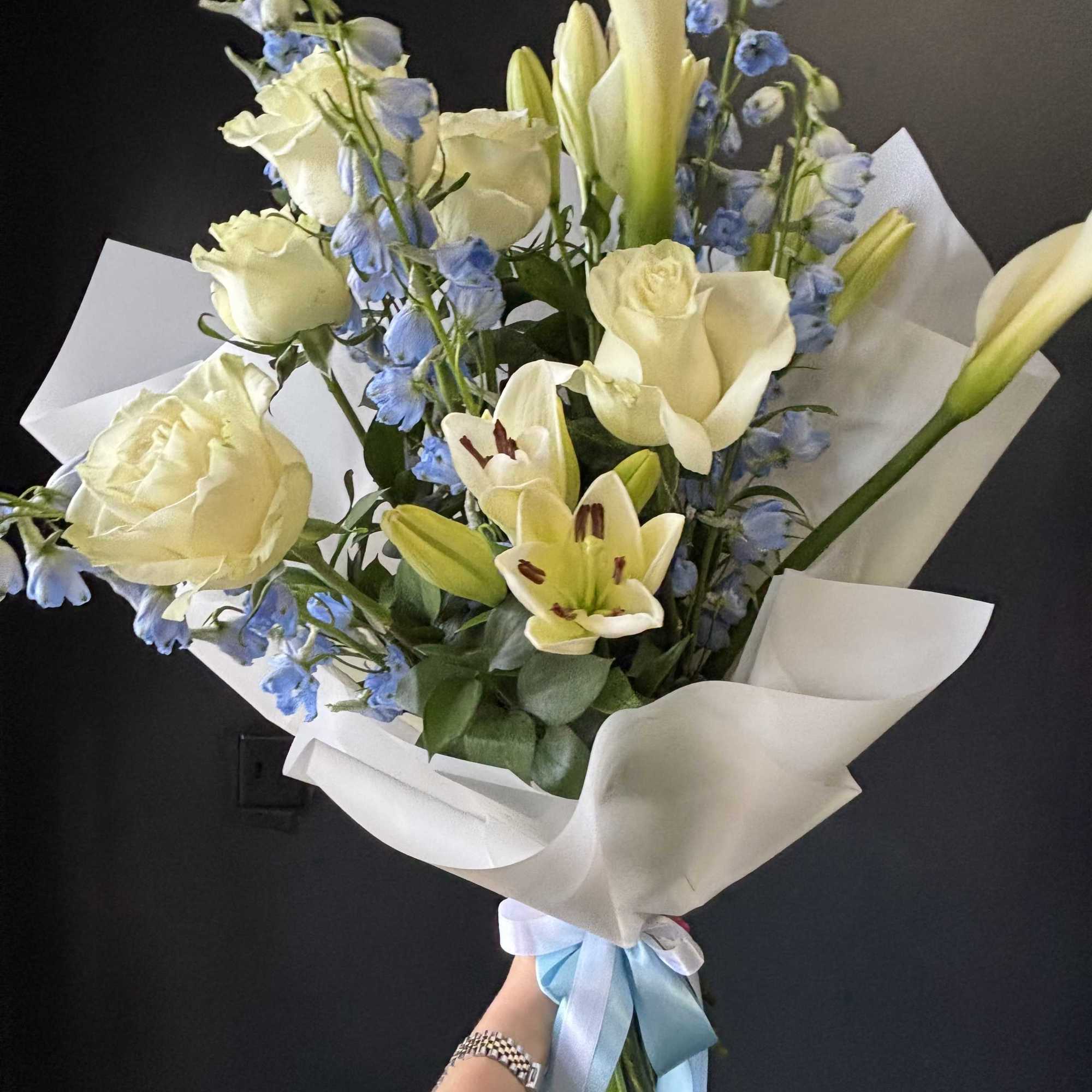 A refined and airy arrangement featuring a statement ivory calla lily, creamy