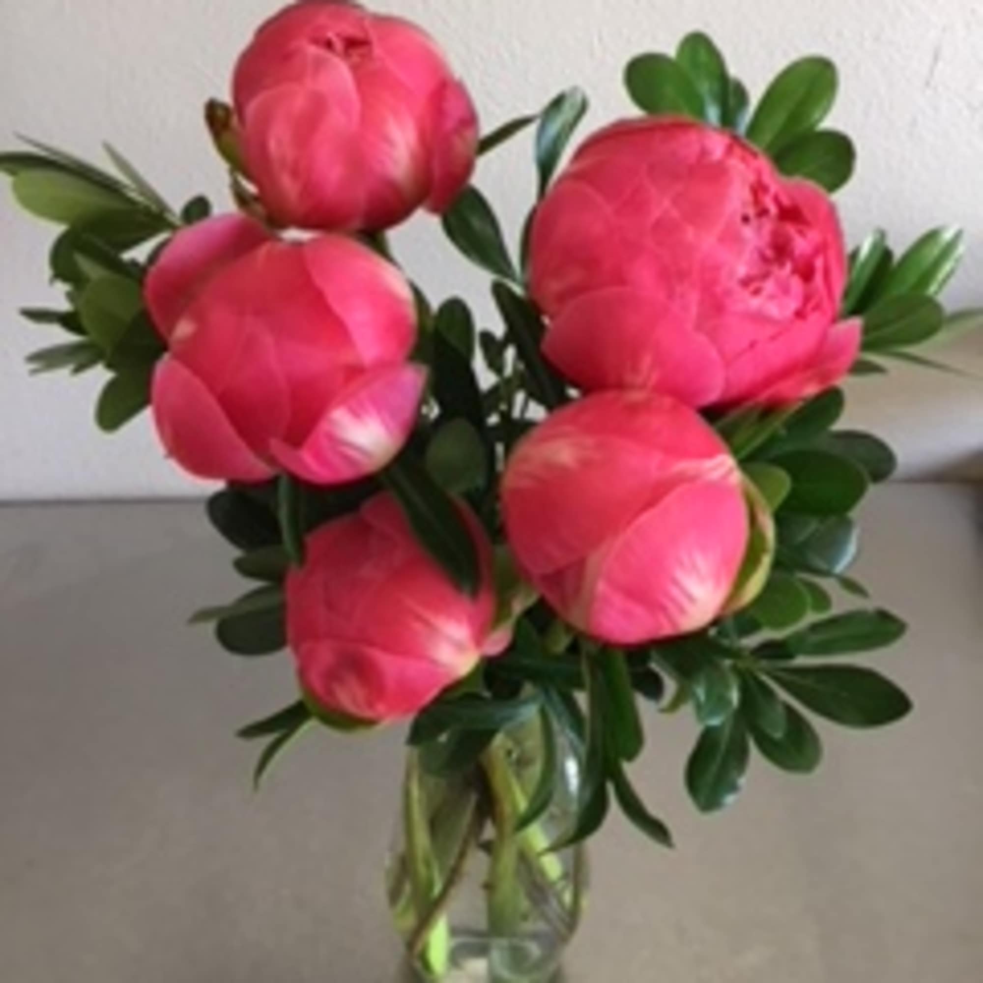 Pink peonies arranged in a clear glass vase