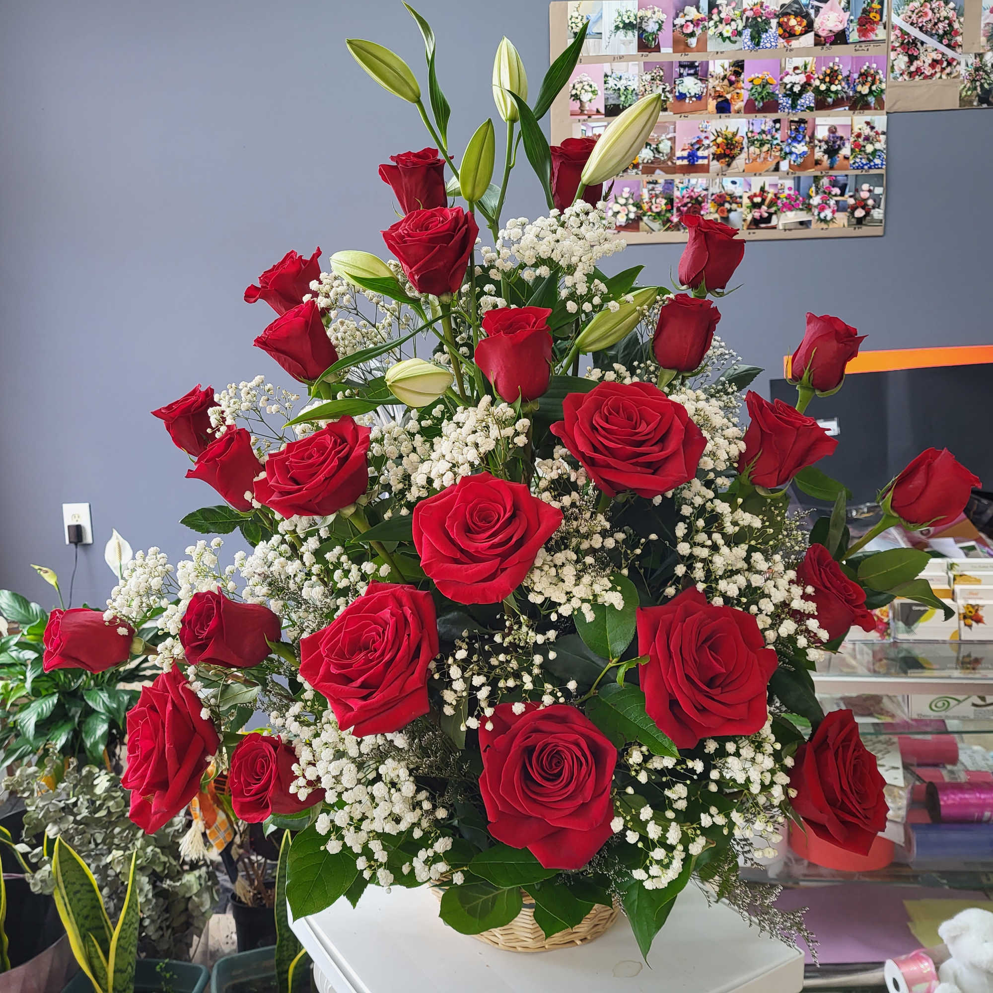 Large bouquet of red roses and white baby's breath in a basket