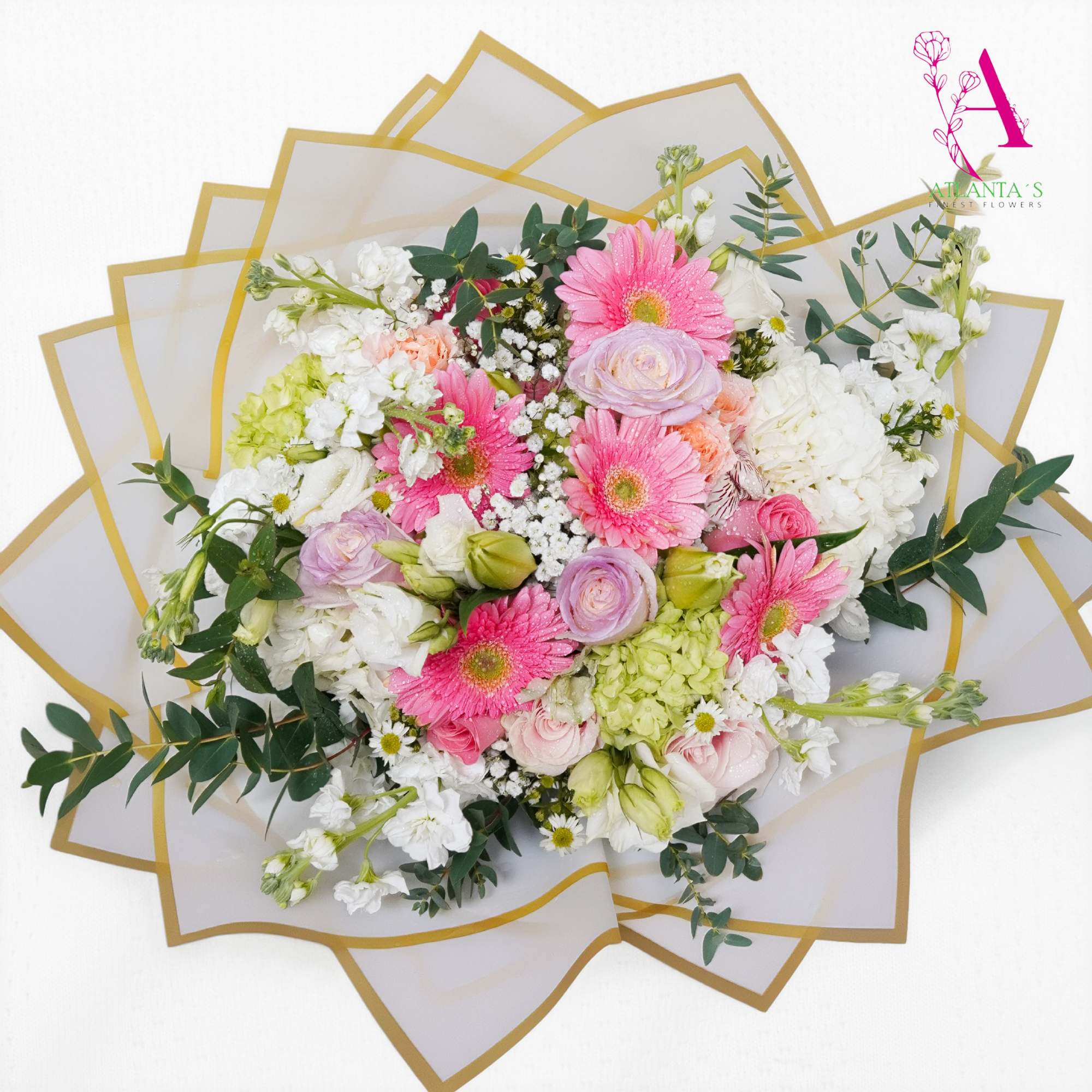 A charming garden-style bouquet featuring soft pink gerbera daisies, pastel roses, lush