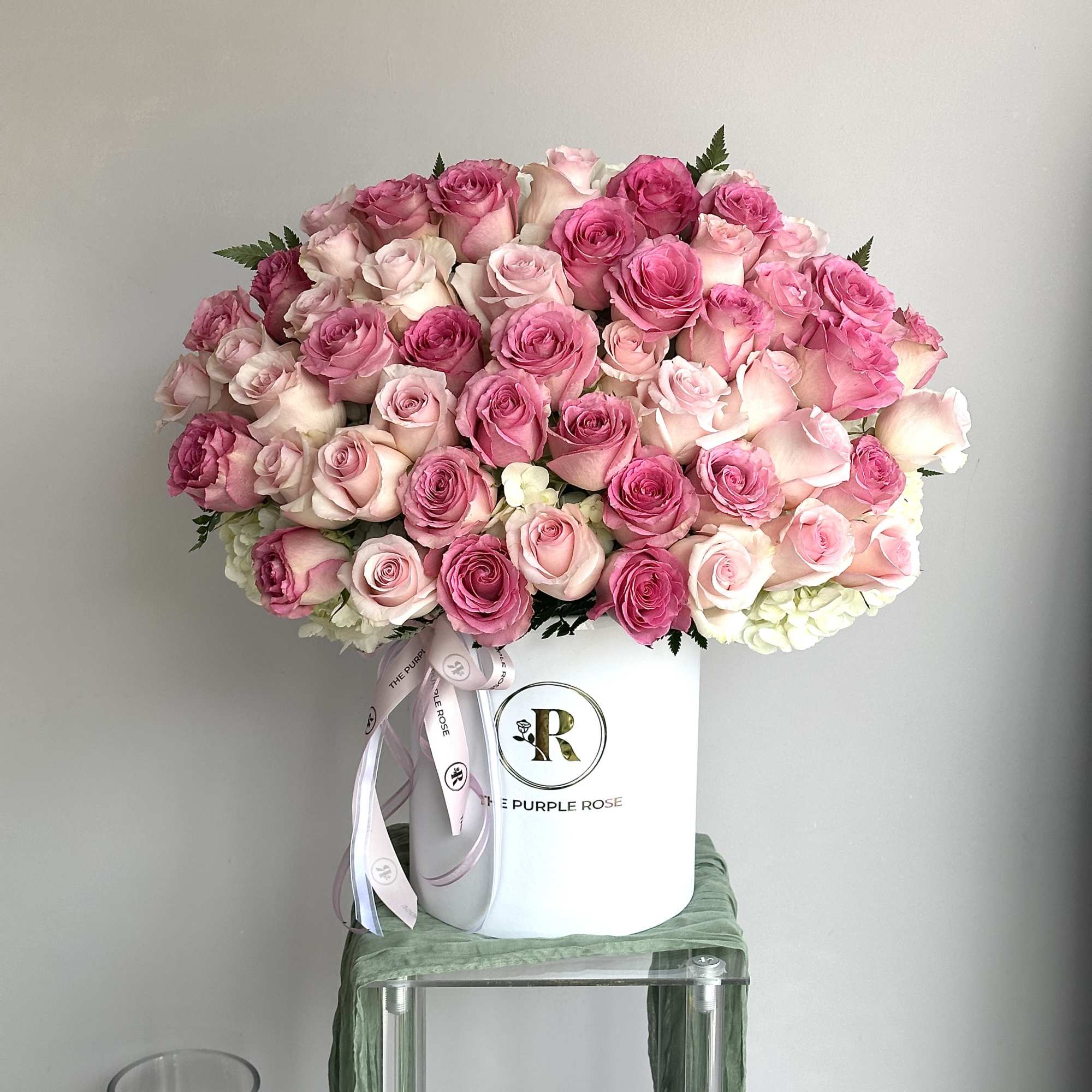 Large dome of pink and blush roses in a white hatbox with ribbon