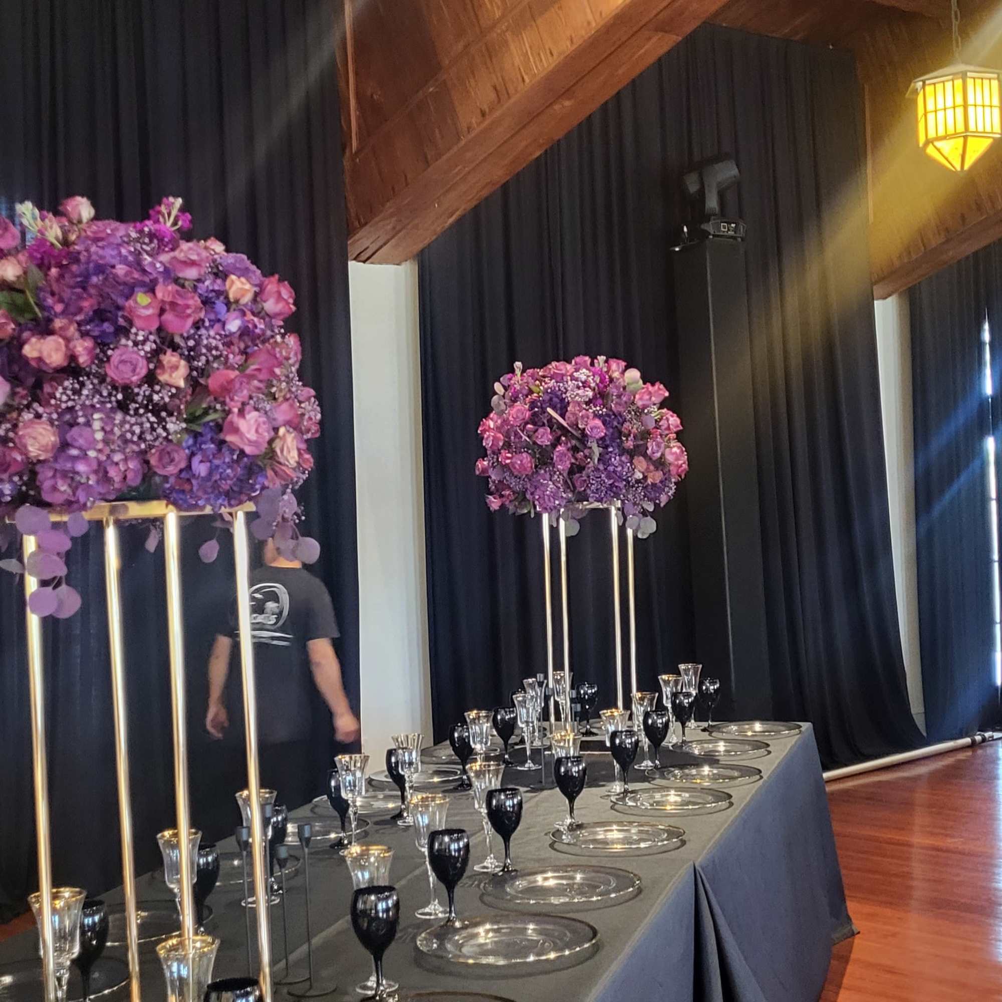 A lush, elevated centerpiece in rich purple tones-this flower arrangement for special