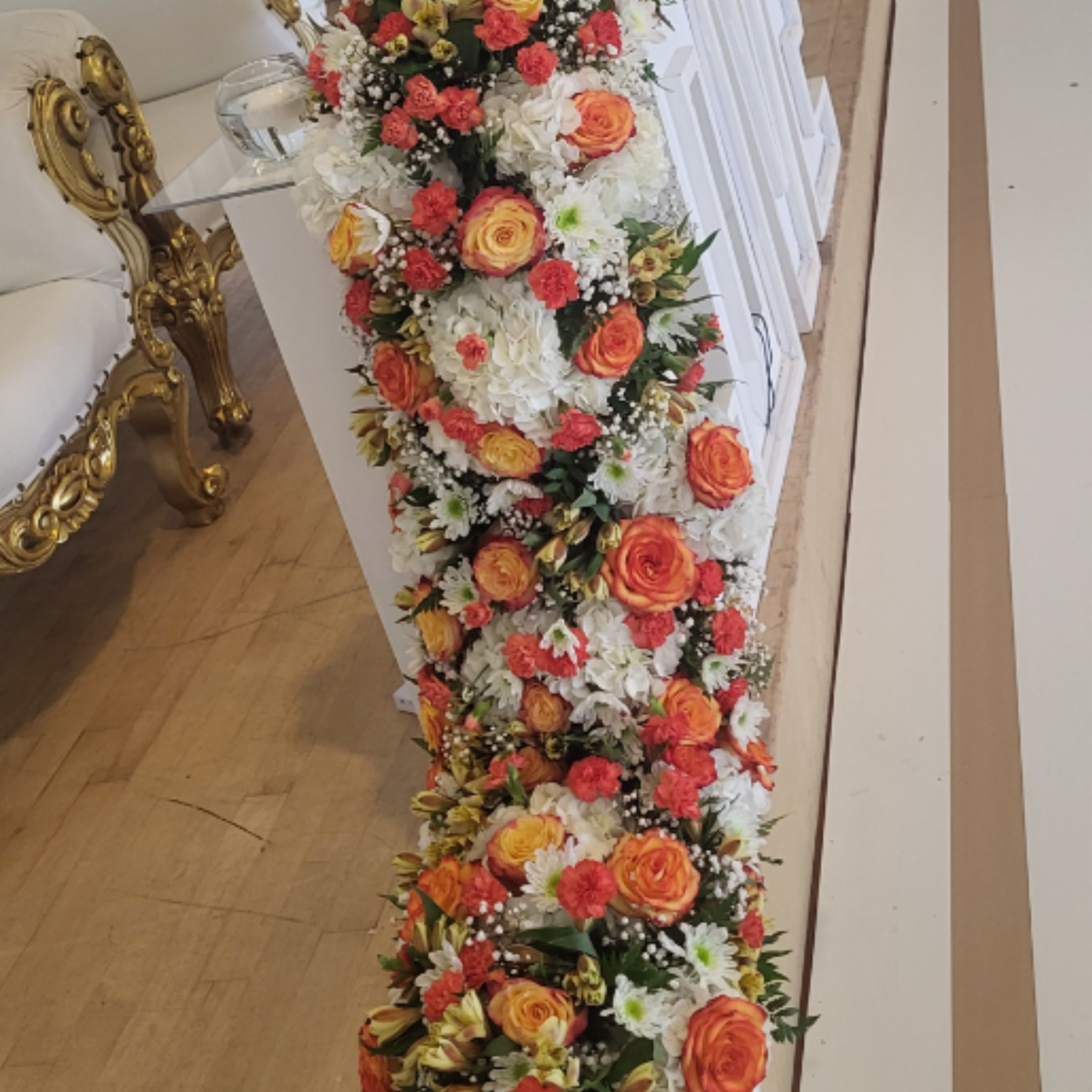 A dramatic long hanging main centerpiece that reads like a cascading floral