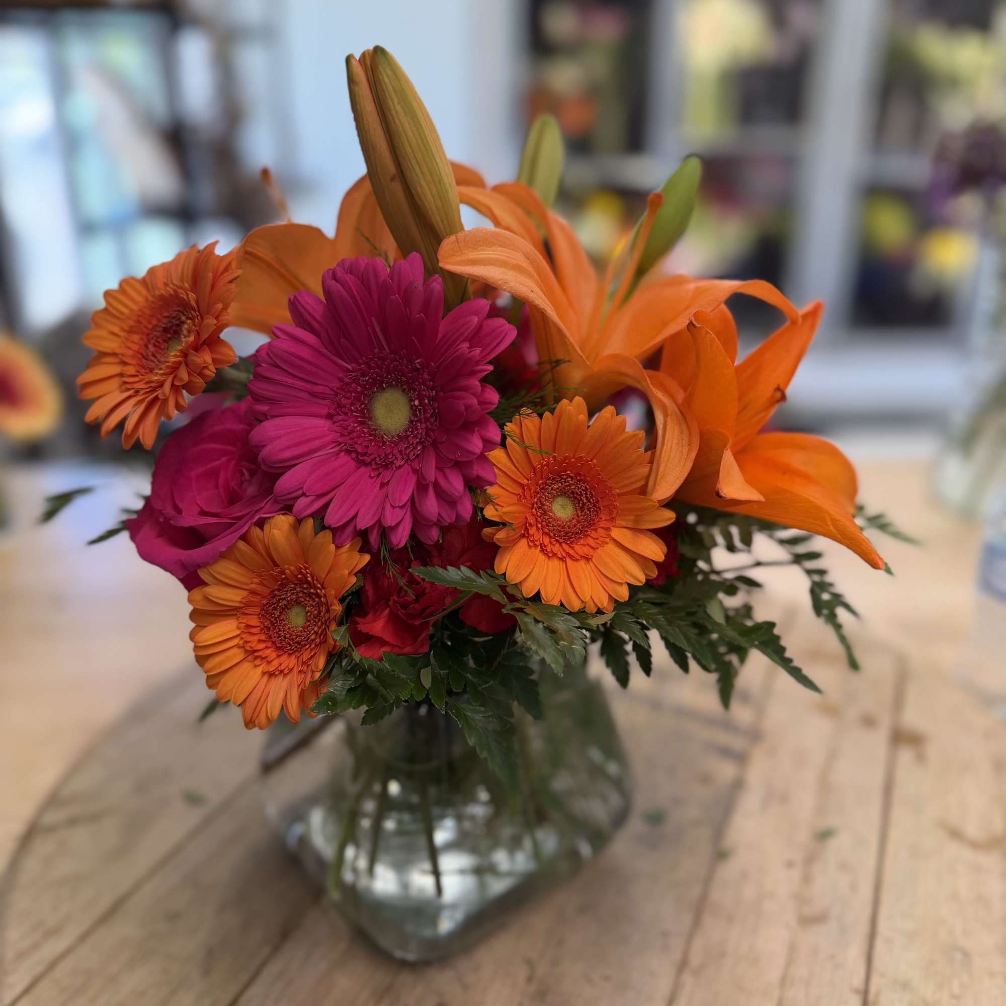 Stunning roses, Gerbera daisies, lilies, and carnations make a dazzling hot pink