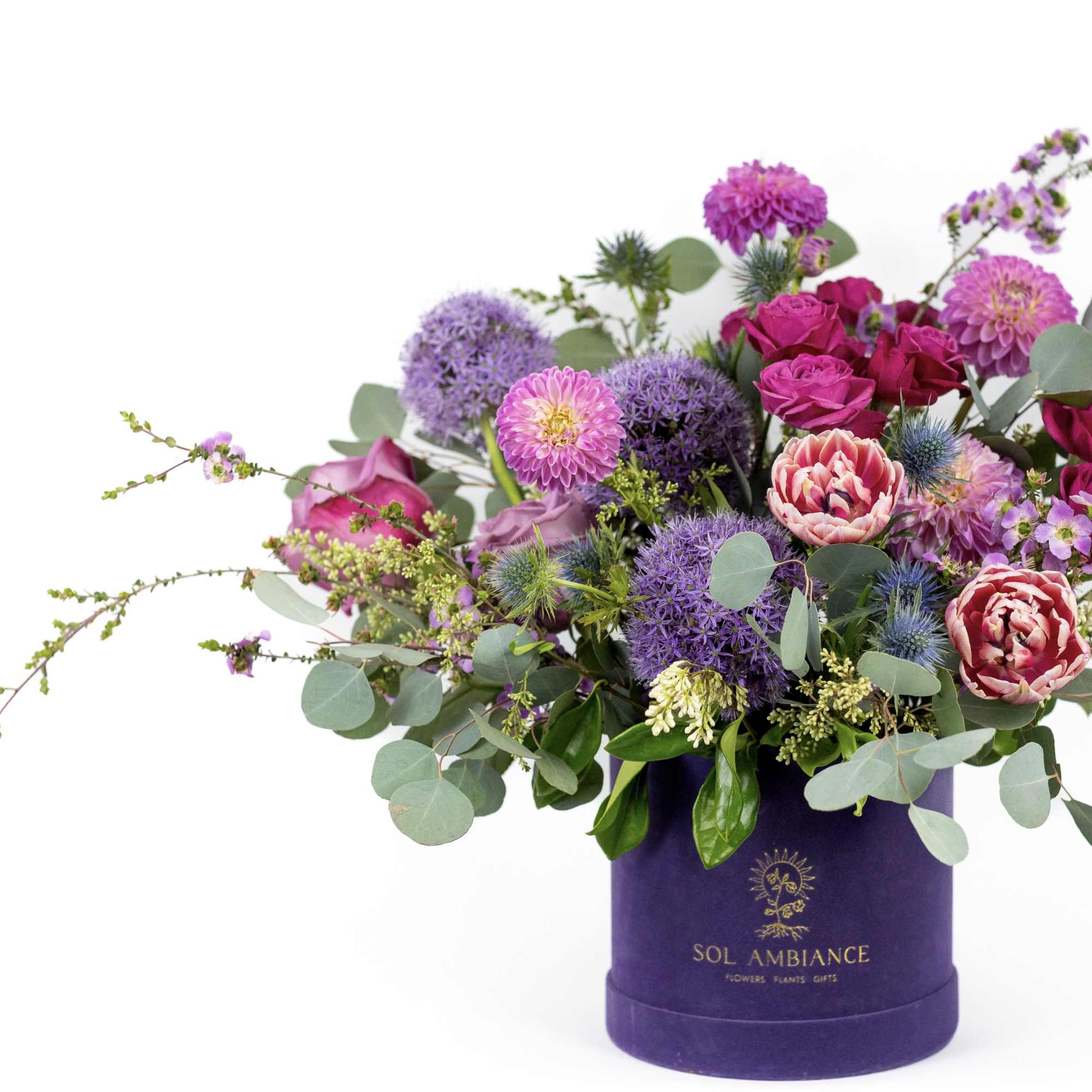Purple and pink mixed bouquet in a purple hat box