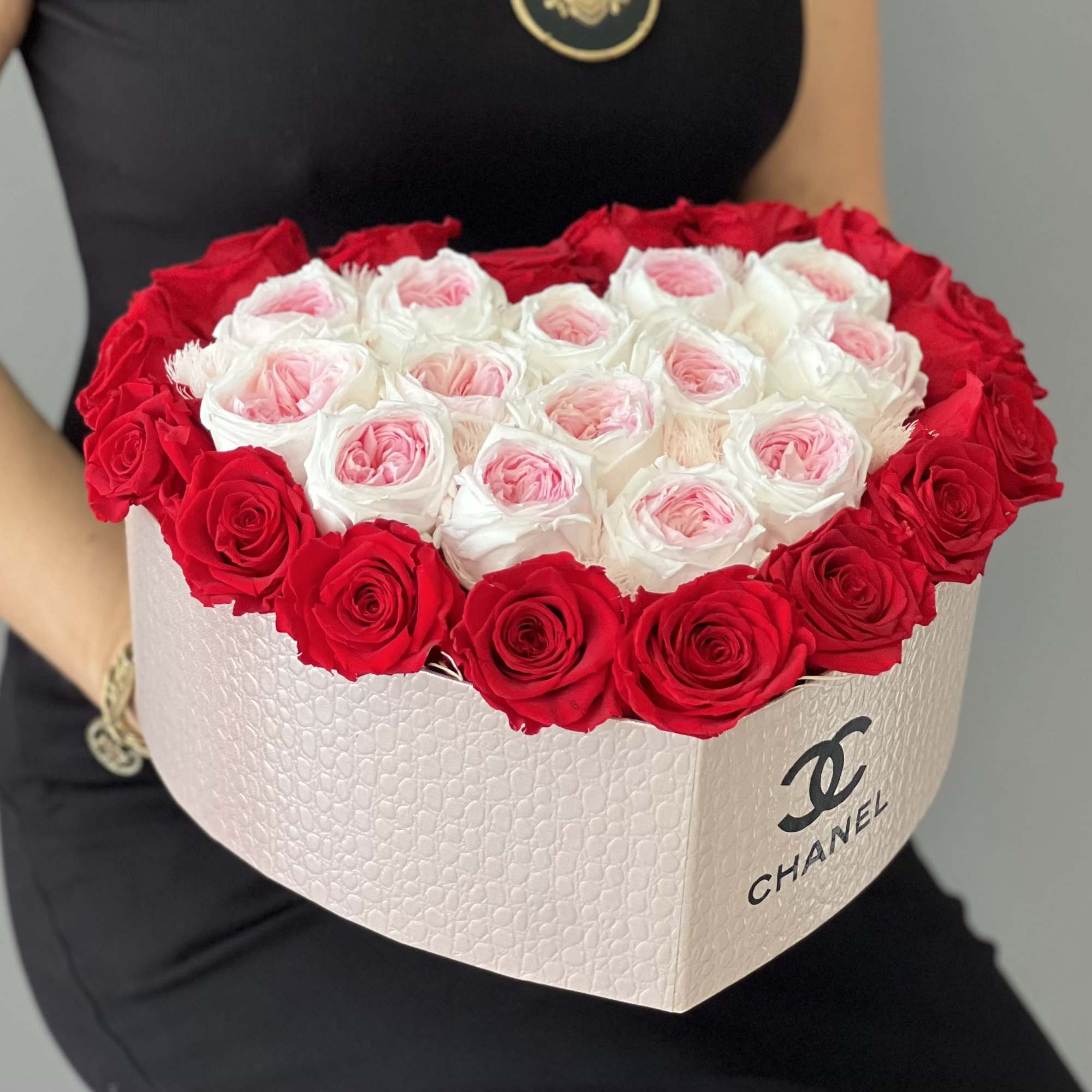 Heart-shaped box of red and white roses with pink centers
