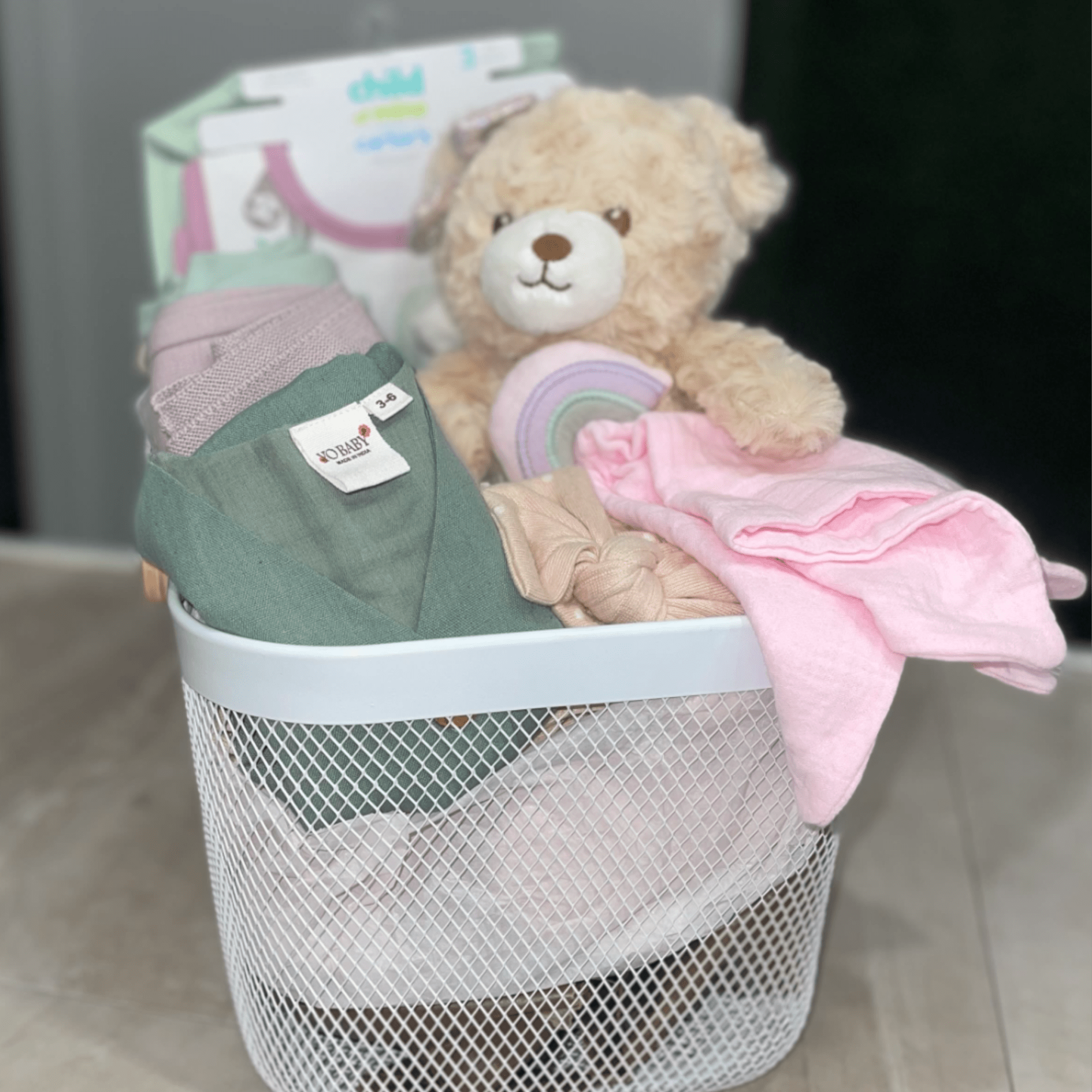 Soft pastels and cuddly textures make this Hello Baby Girl Basket the