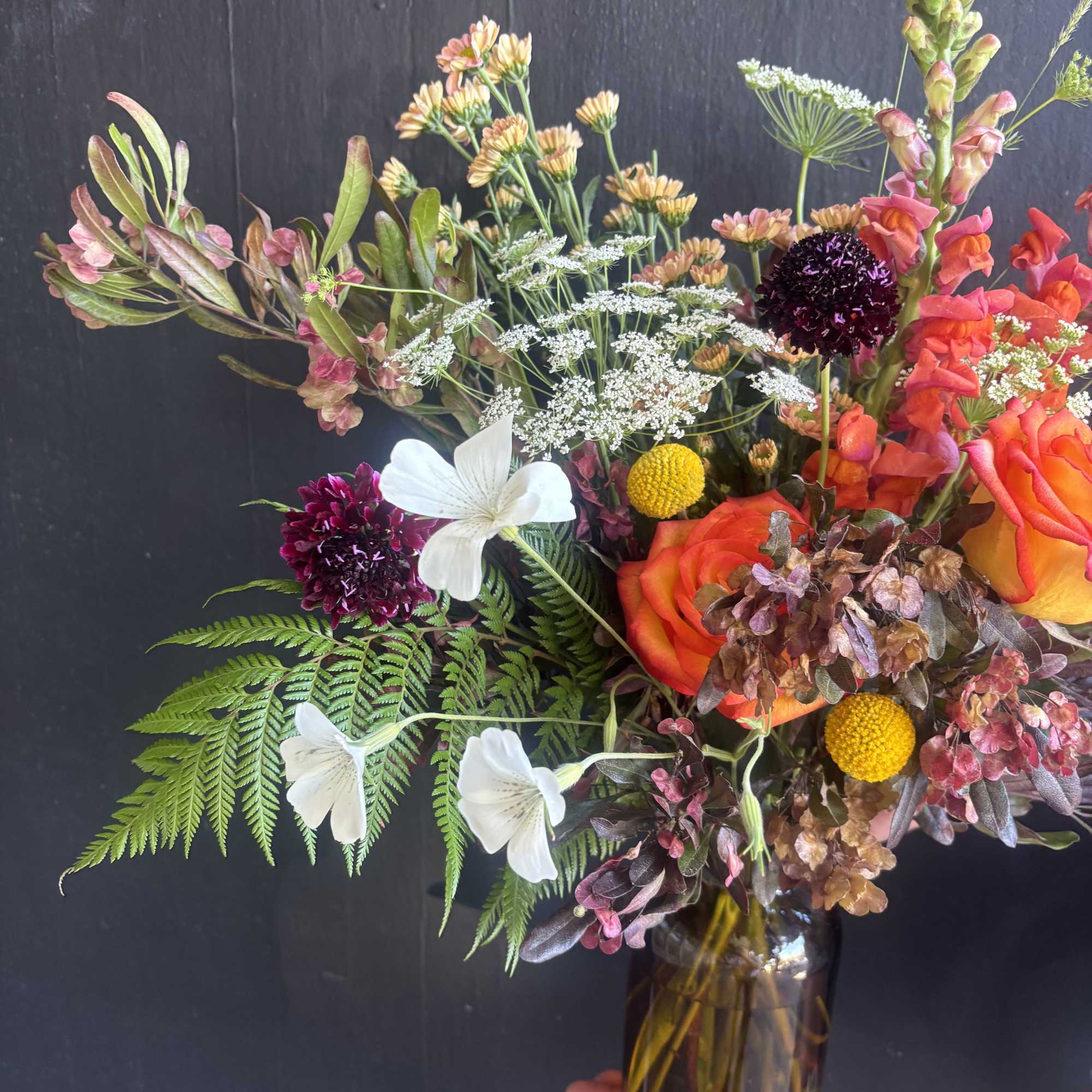 A mix of unique flowers like scabiosa, Queen Anne's Lace and snapdragons.